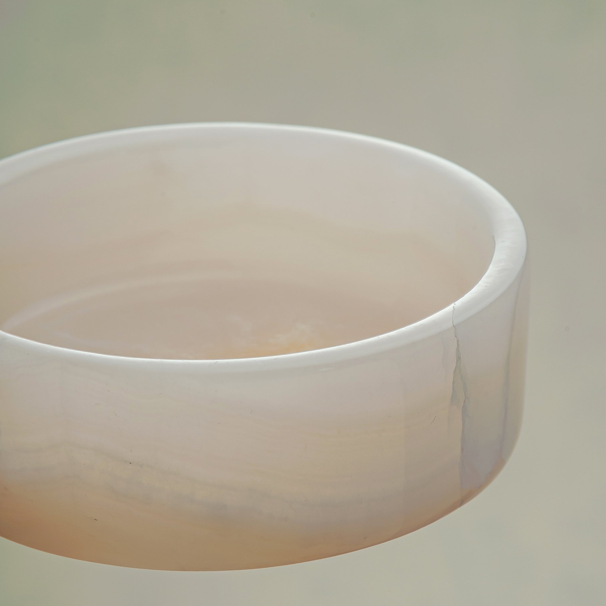 handcrafted onyx bowl in low cylindrical shape with soft white and blush tones for modern decor
