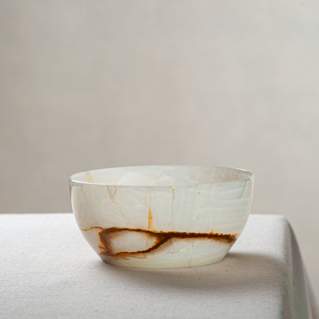 Unique natural onyx bowl with soft translucent surface and warm accent lines
