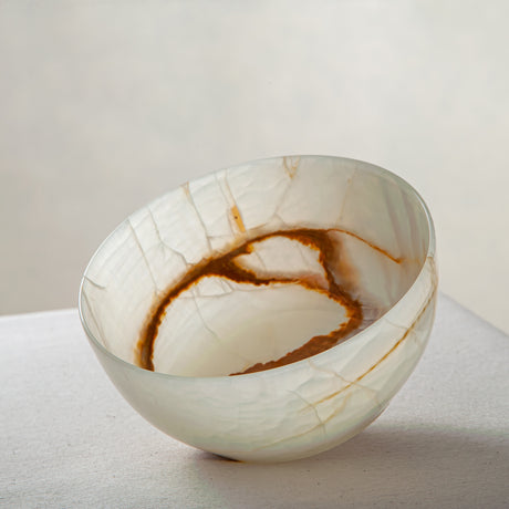Unique natural onyx bowl with soft translucent surface and warm accent lines
