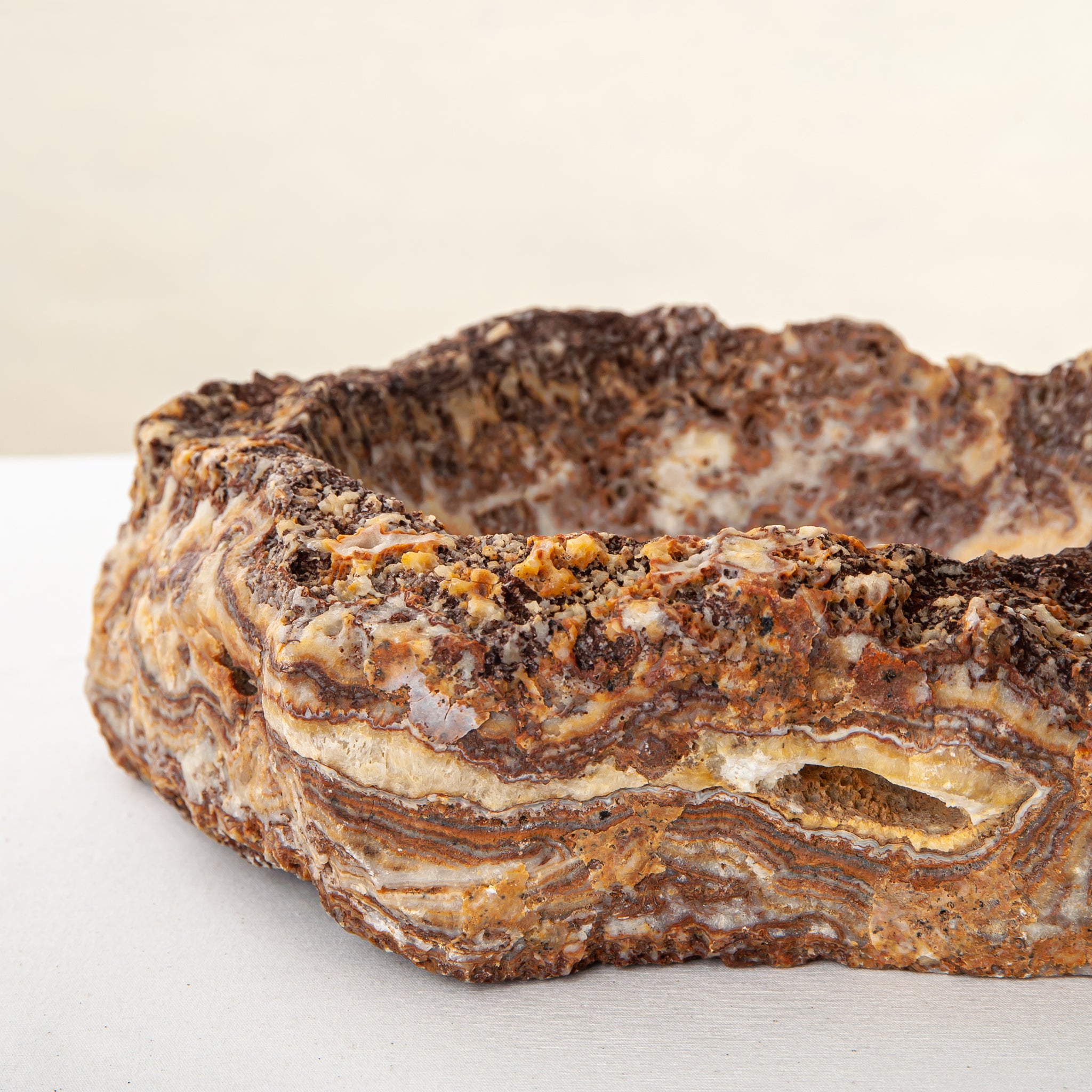 handcrafted onyx bowl with layered amber and ivory veining for luxury table decor
