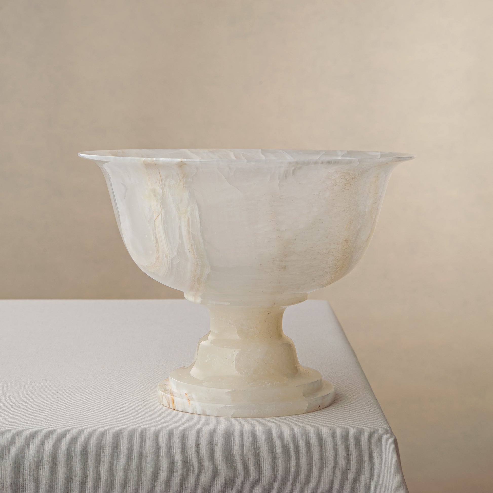 handcrafted onyx bowl with pedestal base and translucent ivory tones for luxury centerpiece decor
