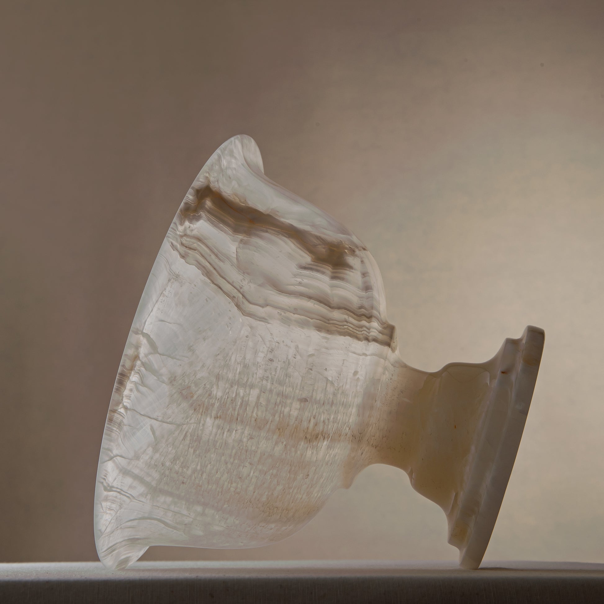 handcrafted onyx bowl with pedestal base and translucent ivory tones for luxury centerpiece decor
