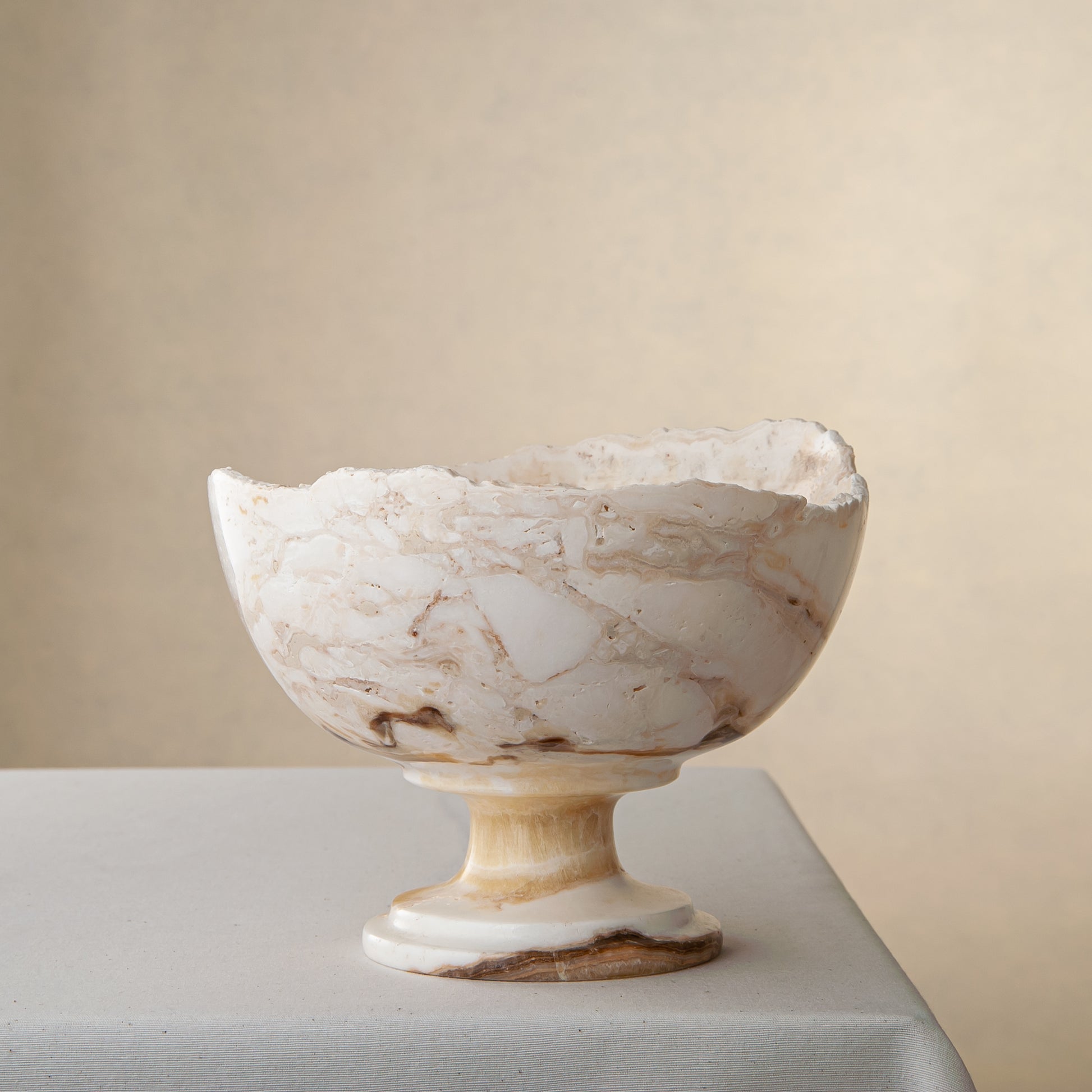 handcrafted onyx bowl with pedestal base in ivory tones and natural veining for luxury decor
