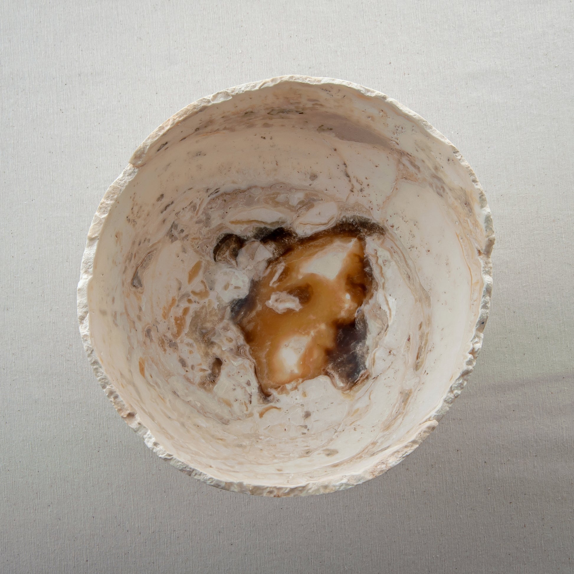 handcrafted onyx bowl with pedestal base in ivory tones and natural veining for luxury decor
