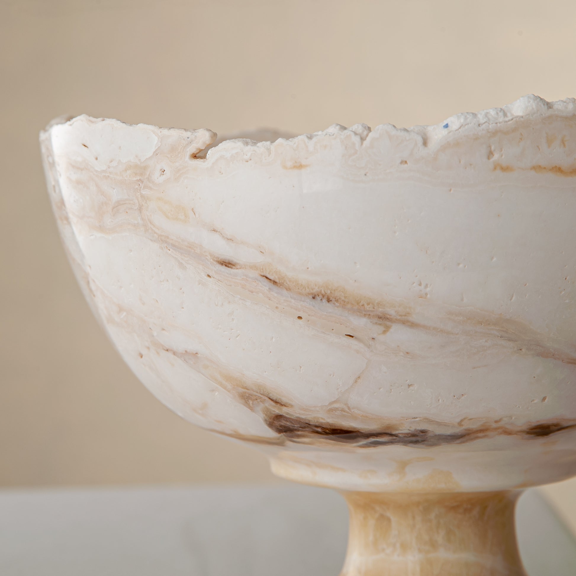 handcrafted onyx bowl with pedestal base in ivory tones and natural veining for luxury decor

