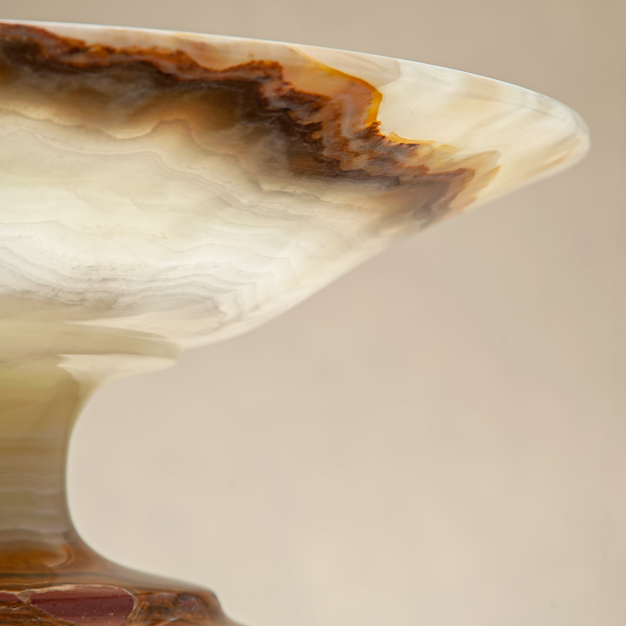 handcrafted onyx bowl with pedestal base and translucent layered amber veining for luxury decor

