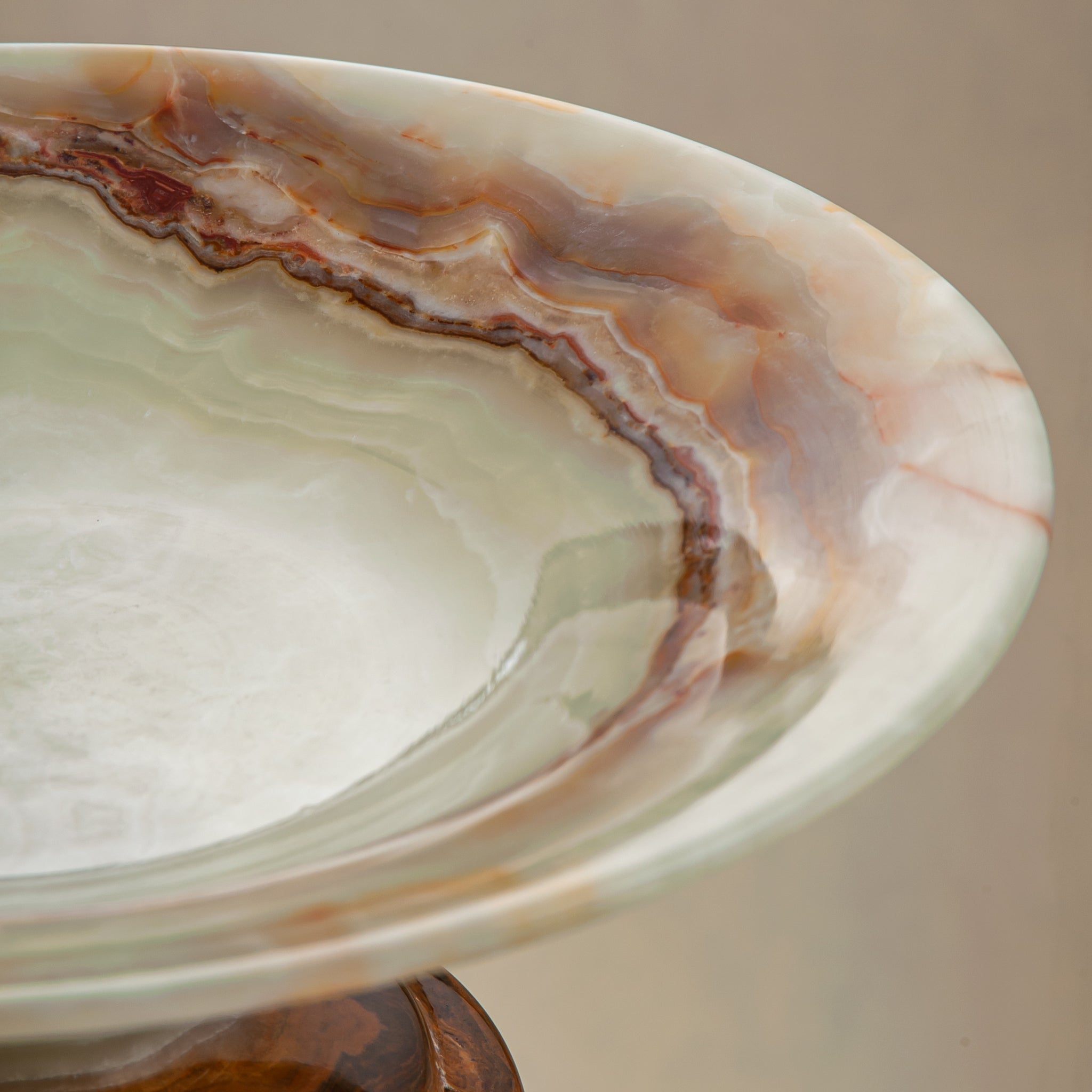 handcrafted onyx bowl with pedestal base and translucent layered amber veining for luxury decor
