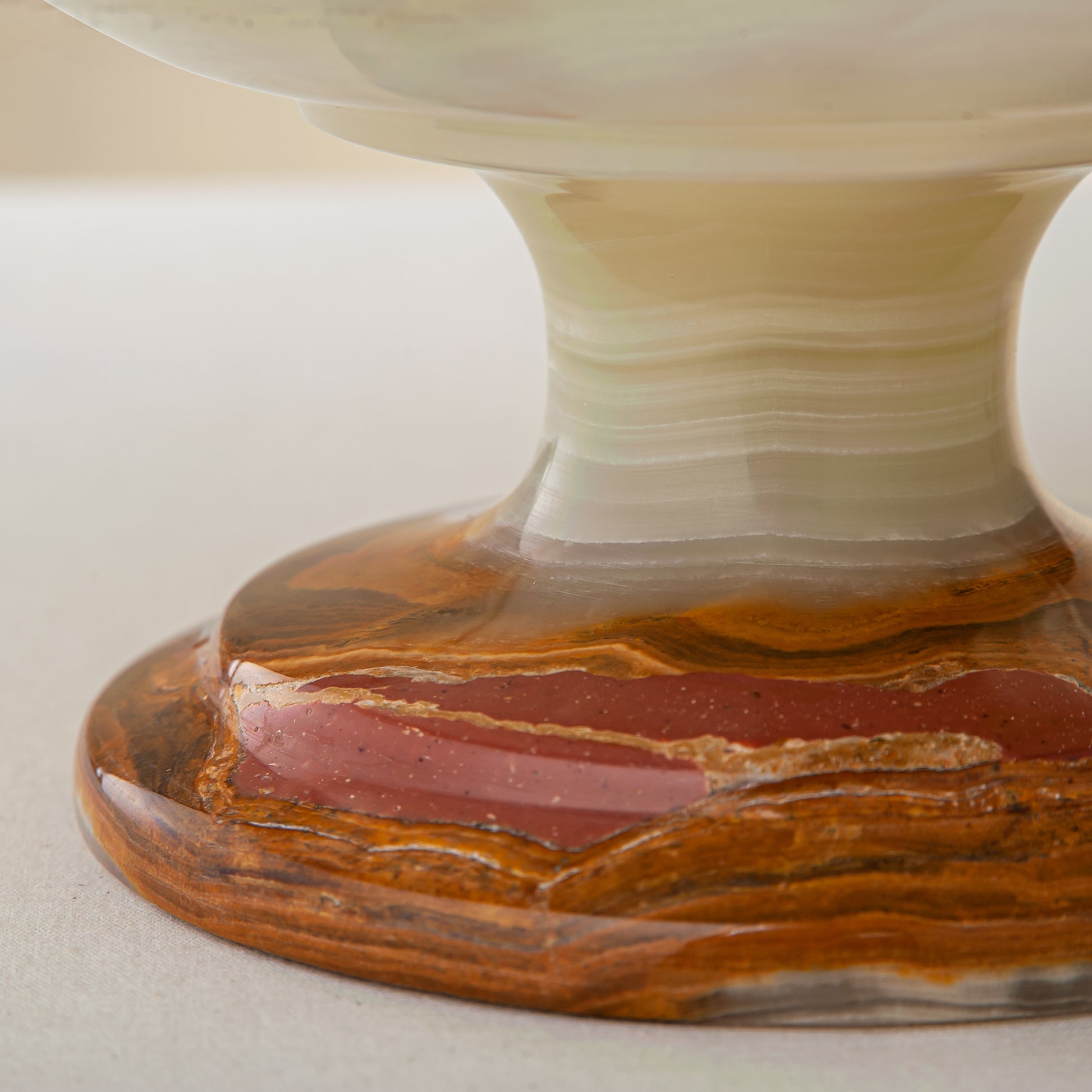 handcrafted onyx bowl with pedestal base and translucent layered amber veining for luxury decor

