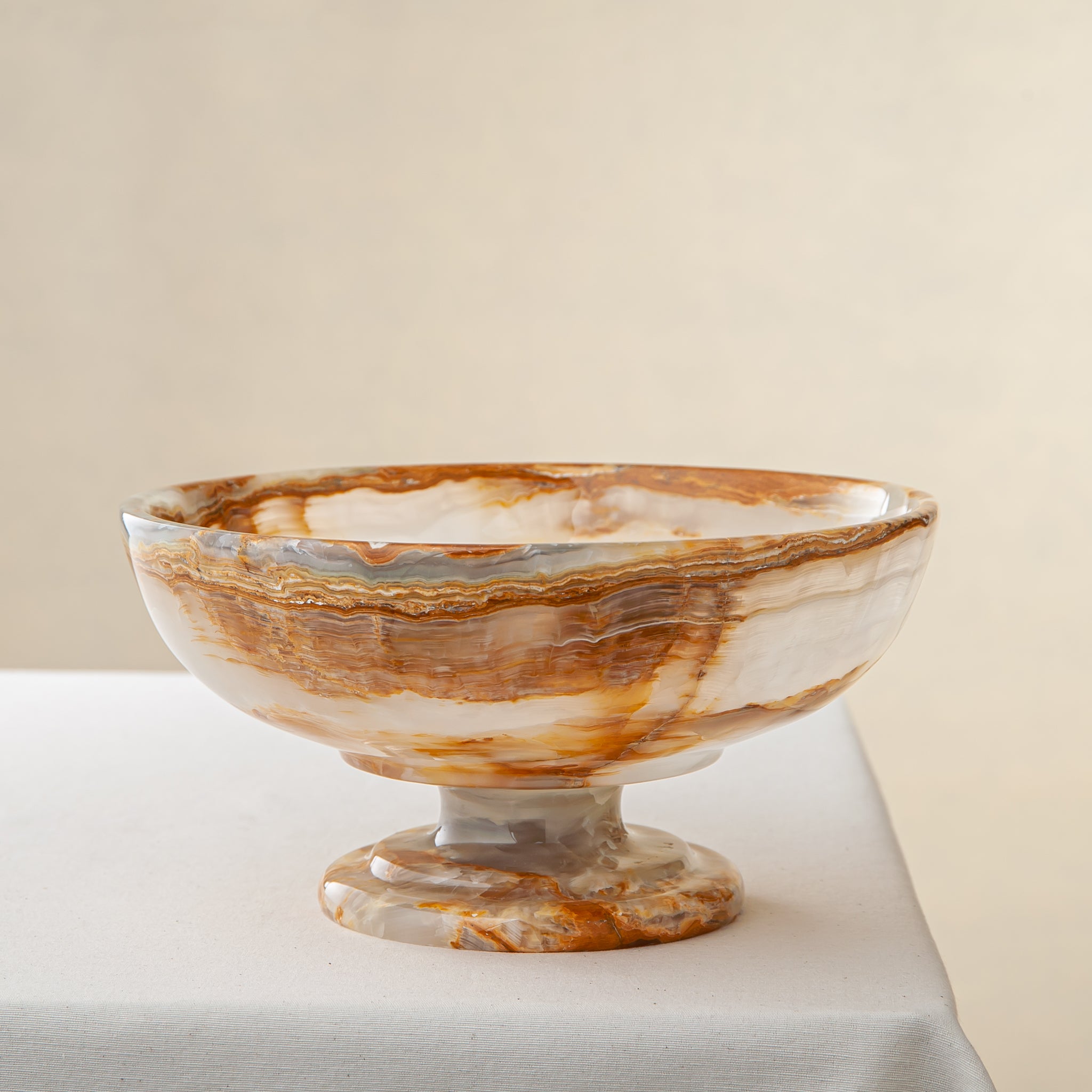 unique natural onyx bowl with irregular rim and warm honey tones as elegant centerpiece
