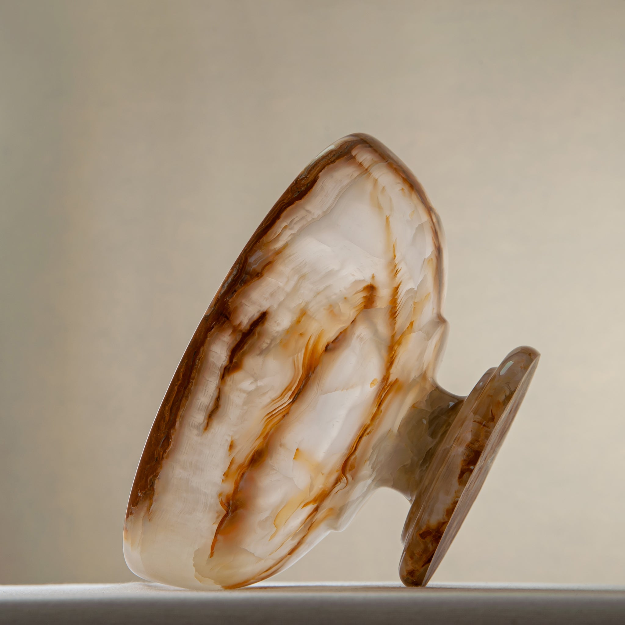 unique natural onyx bowl with irregular rim and warm honey tones as elegant centerpiece
