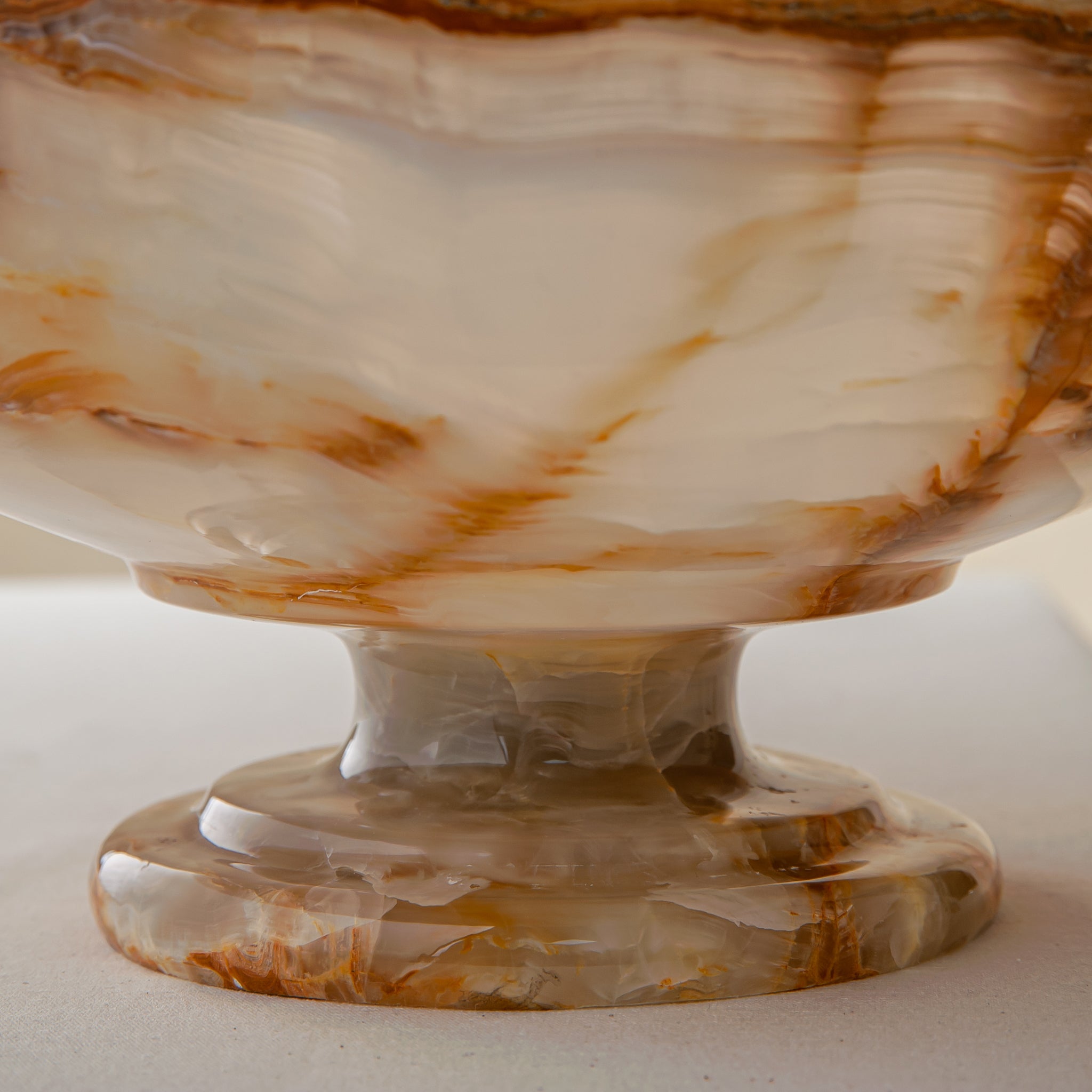 unique natural onyx bowl with irregular rim and warm honey tones as elegant centerpiece
