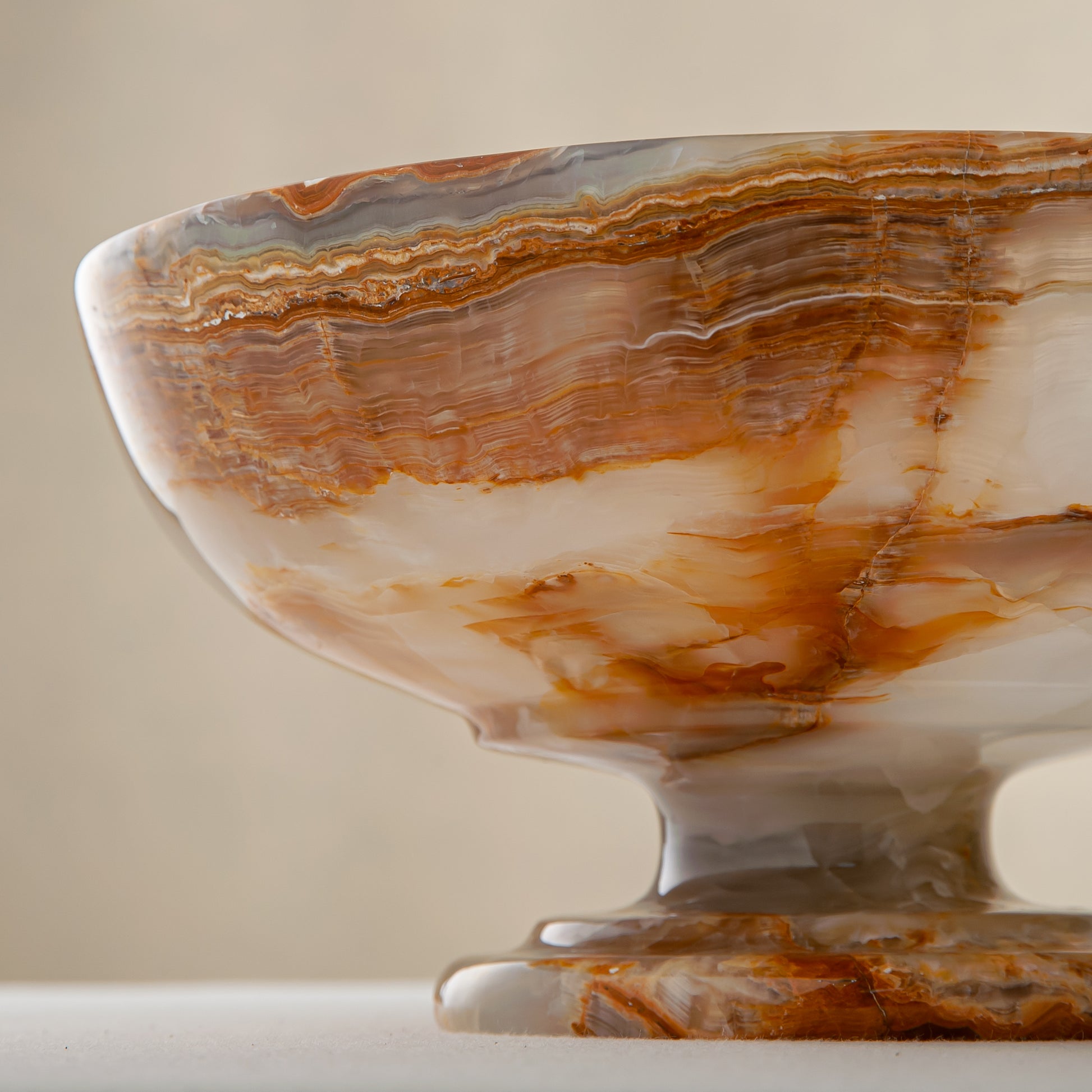 unique natural onyx bowl with irregular rim and warm honey tones as elegant centerpiece
