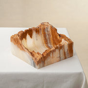handcrafted rough onyx bowl with raw edges in white and amber tones for statement decor
