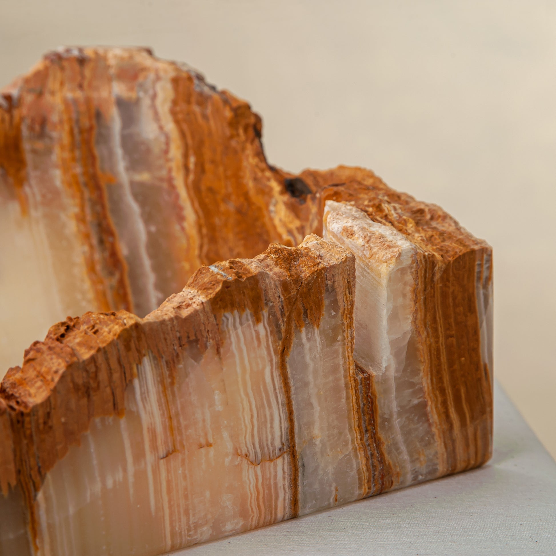handcrafted rough onyx bowl with raw edges in white and amber tones for statement decor
