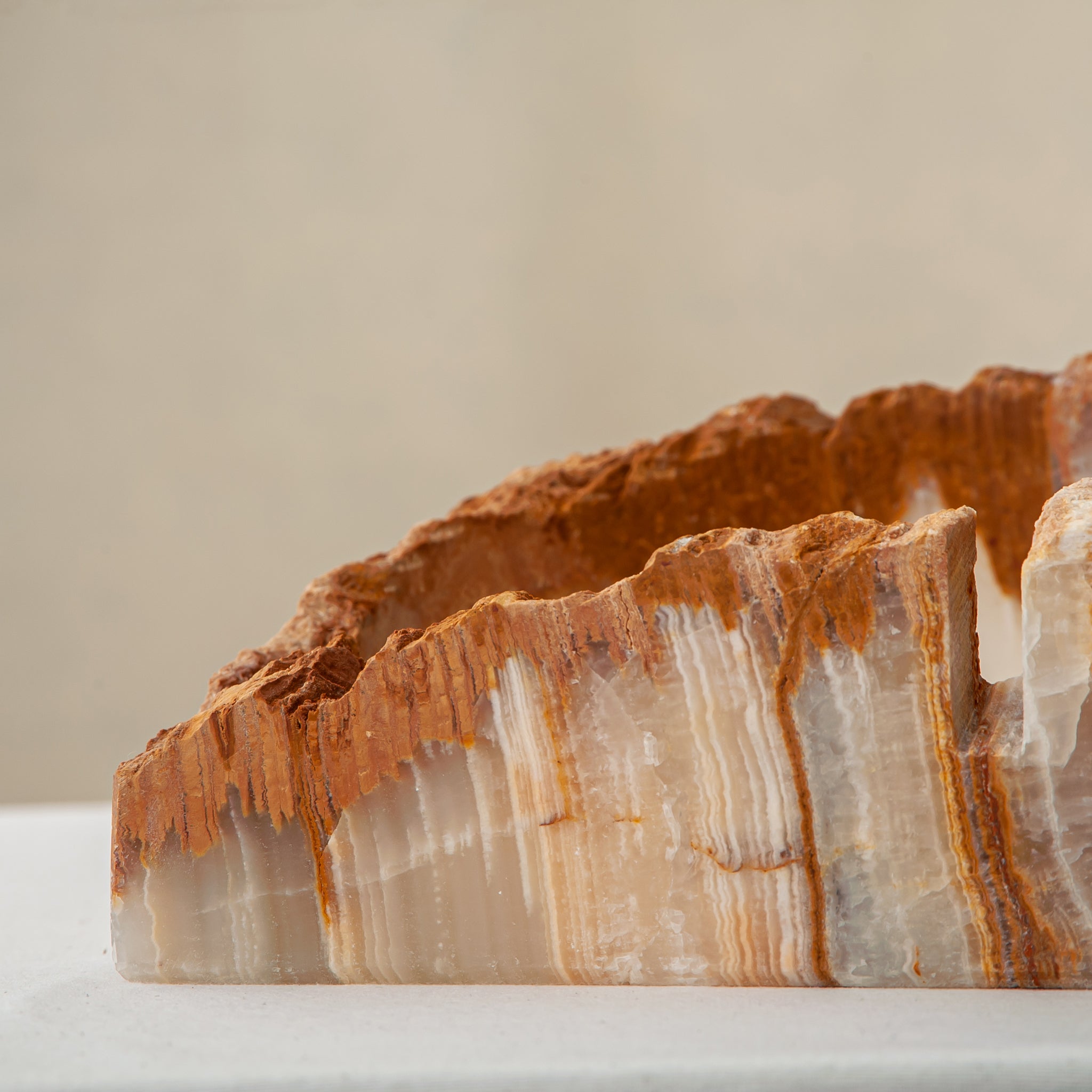 handcrafted rough onyx bowl with raw edges in white and amber tones for statement decor
