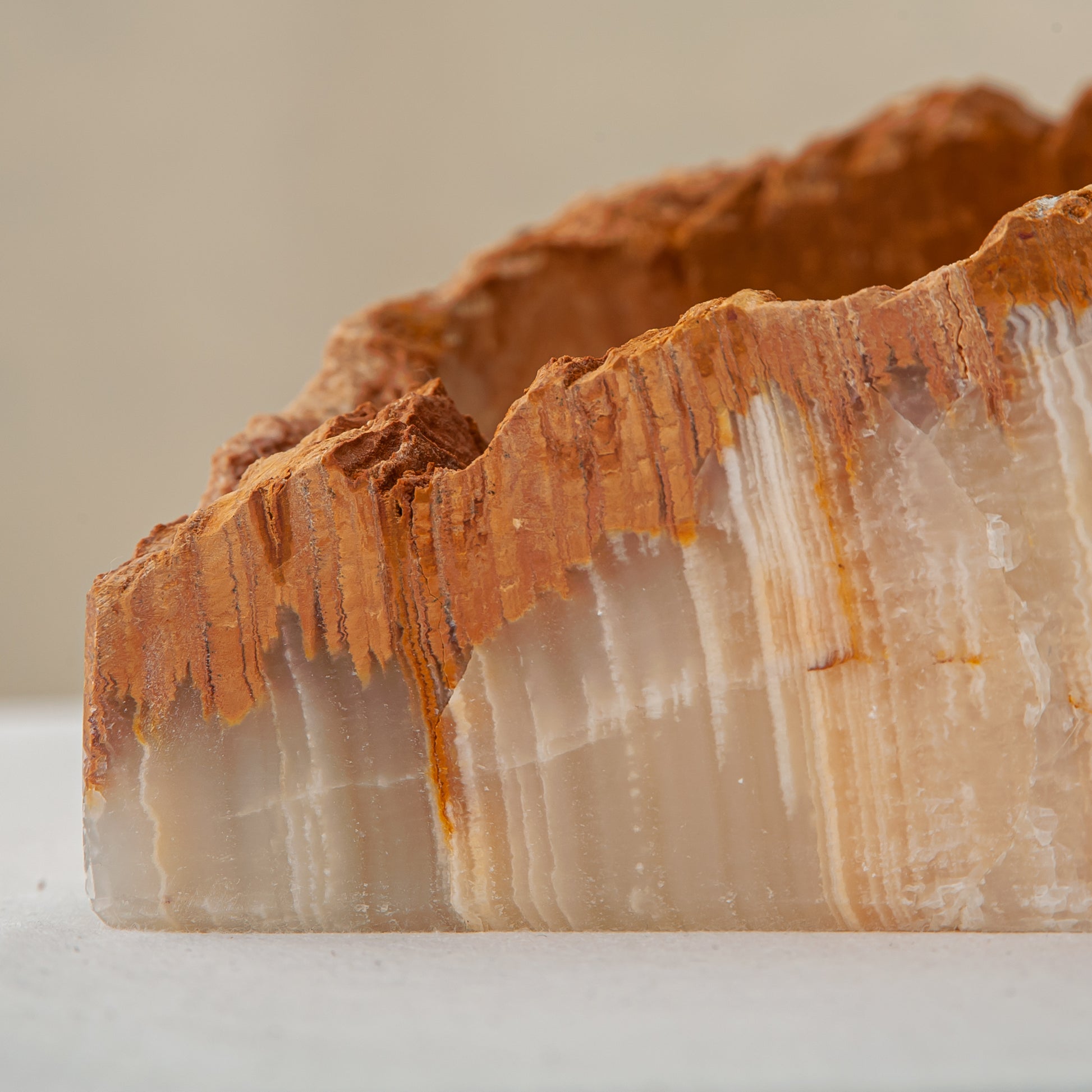 handcrafted rough onyx bowl with raw edges in white and amber tones for statement decor
