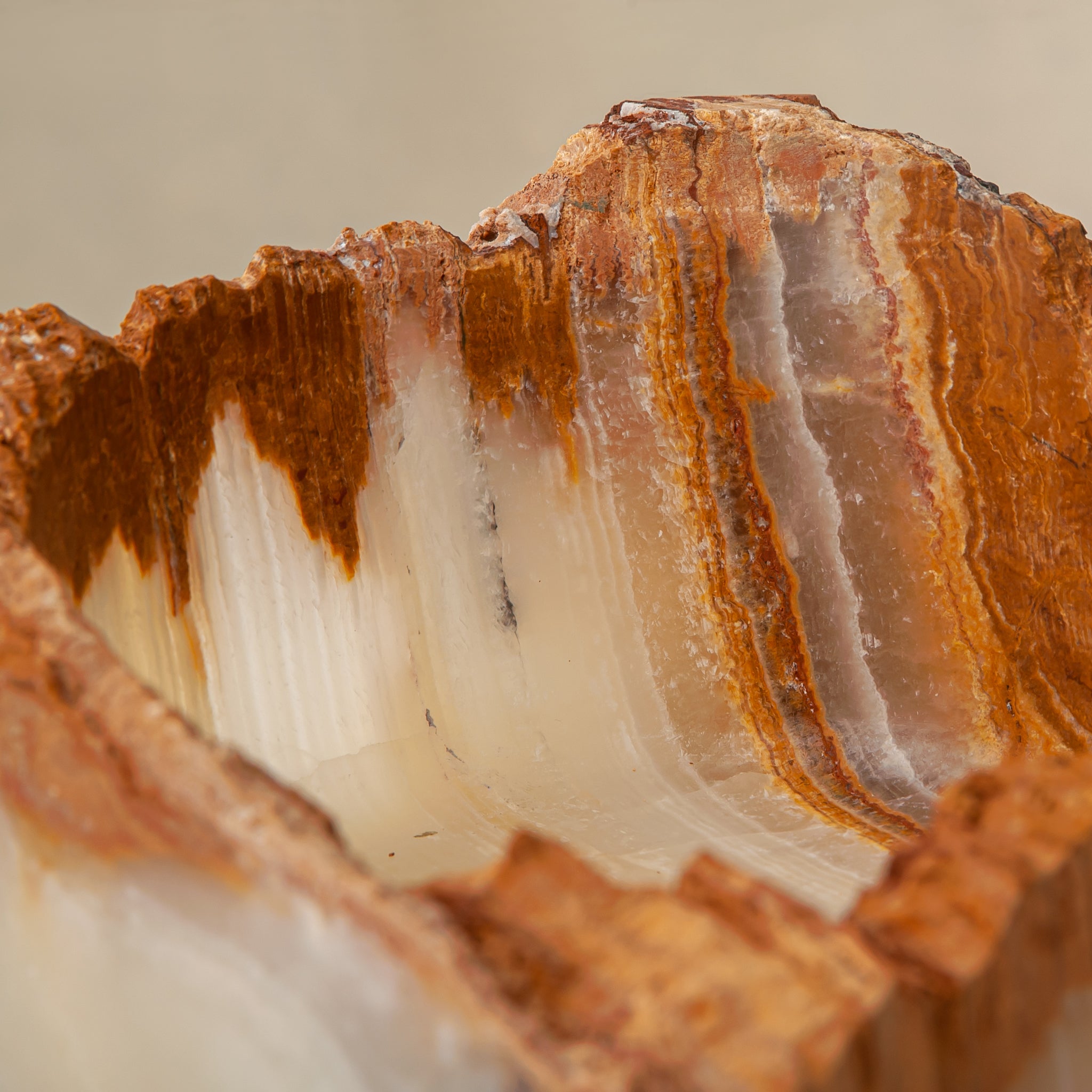 handcrafted rough onyx bowl with raw edges in white and amber tones for statement decor
