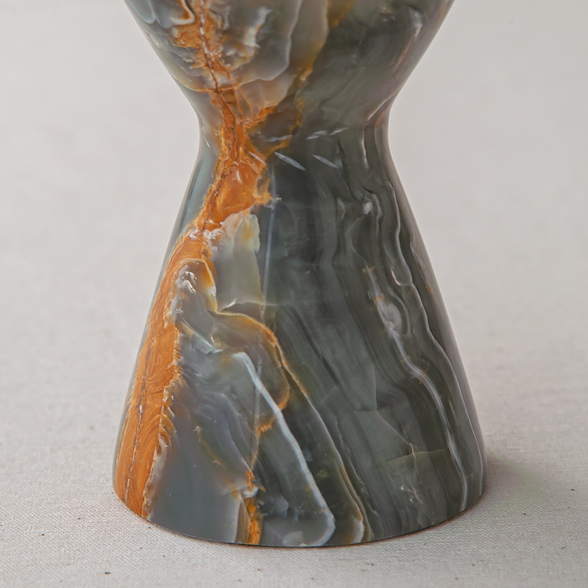 handcrafted onyx candle holder with green grey tones and amber veining for ambient decor
