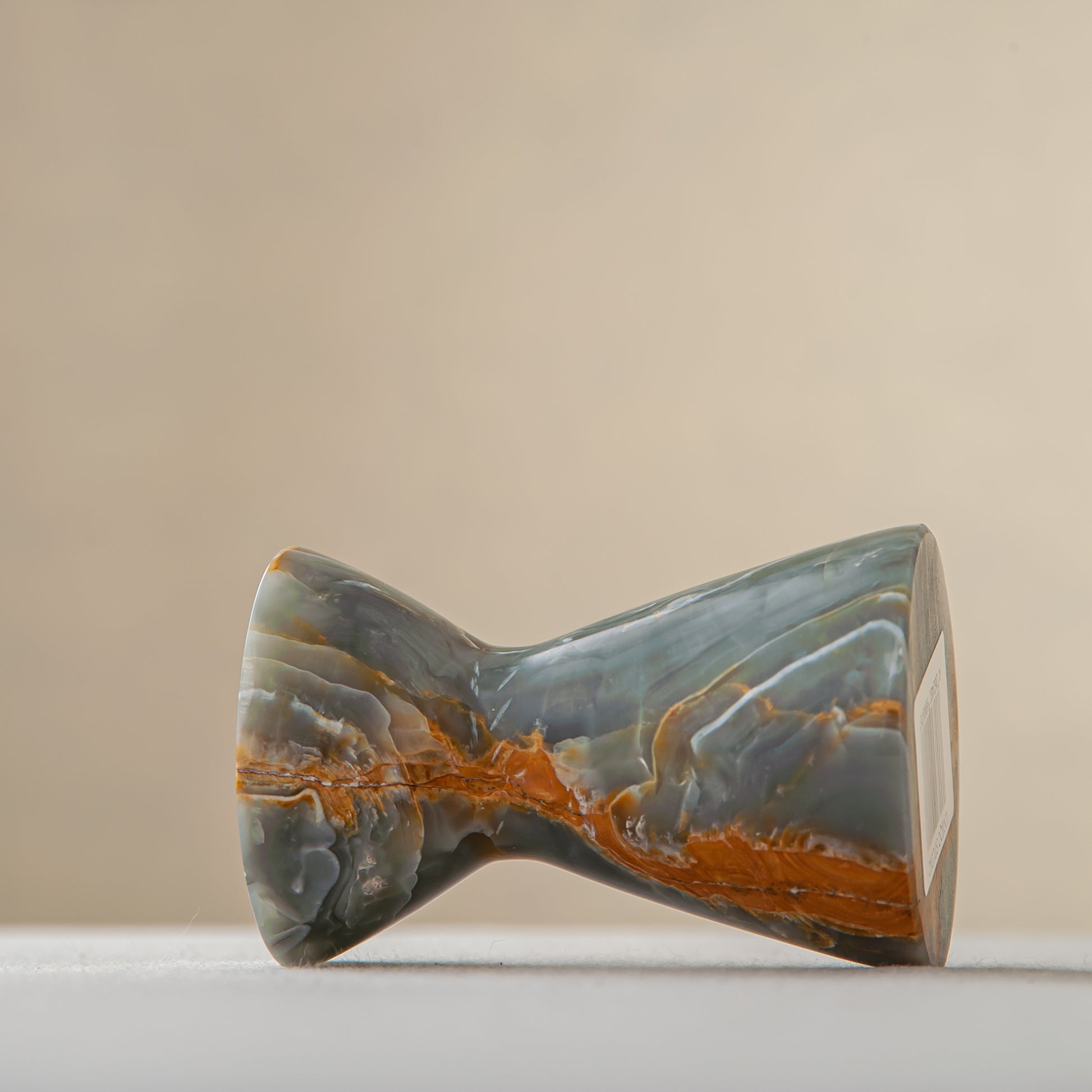 handcrafted onyx candle holder with green grey tones and amber veining for ambient decor