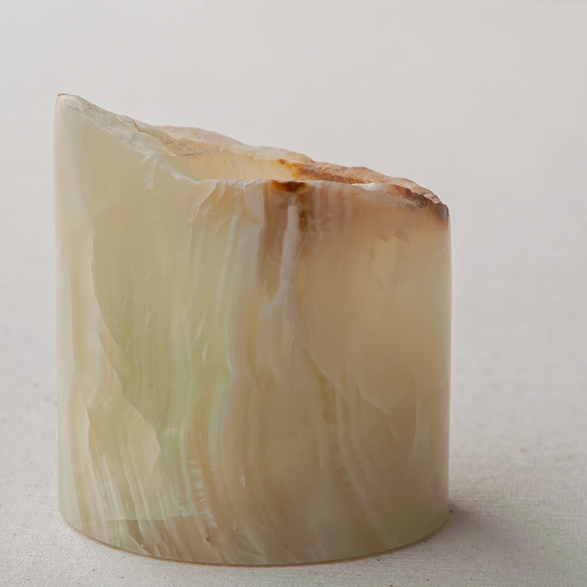 handcrafted onyx candle holder with raw edge ivory and amber veining for modern decor