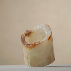 handcrafted onyx candle holder with raw edge ivory and amber veining for modern decor
