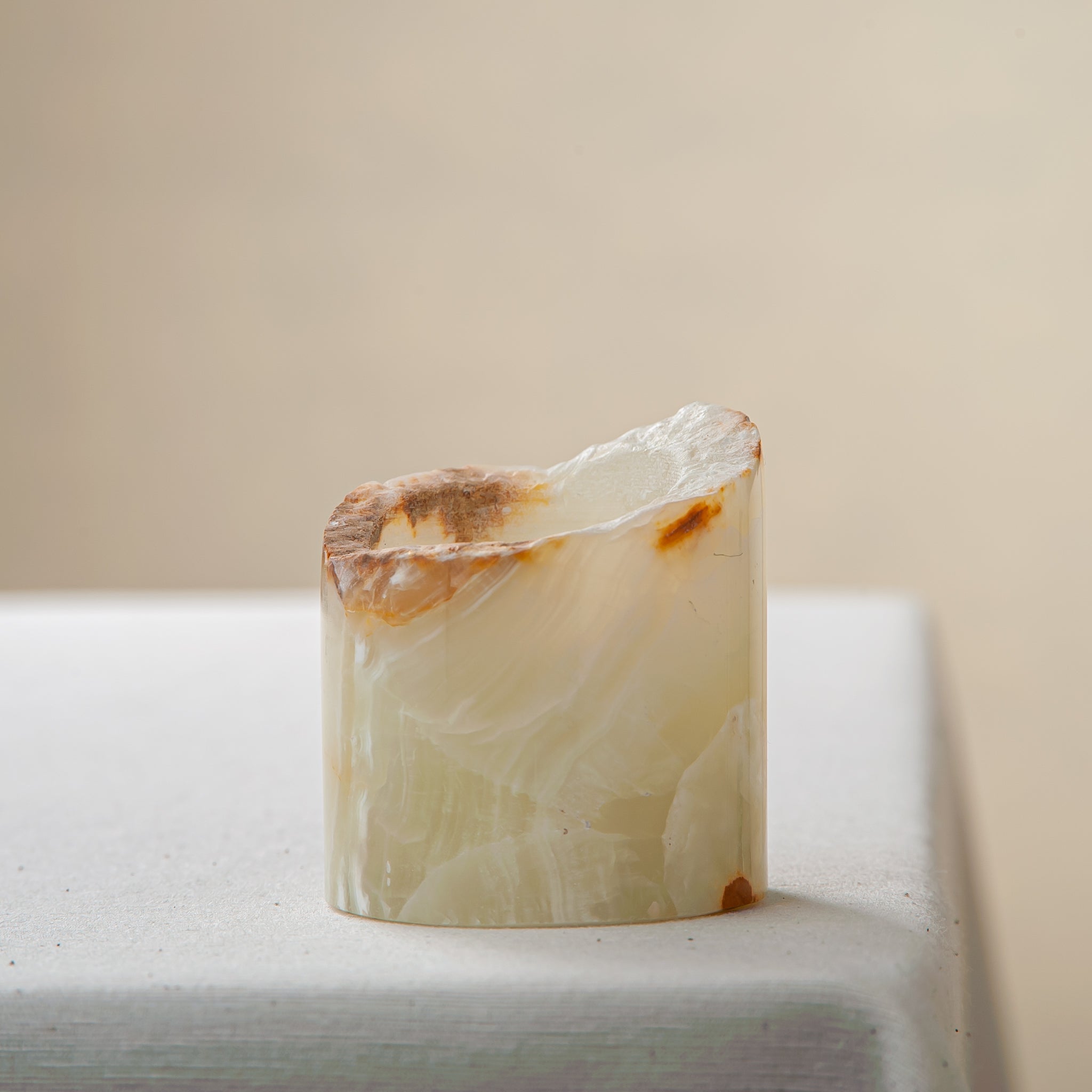 handcrafted onyx candle holder with raw edge ivory and amber veining for modern decor