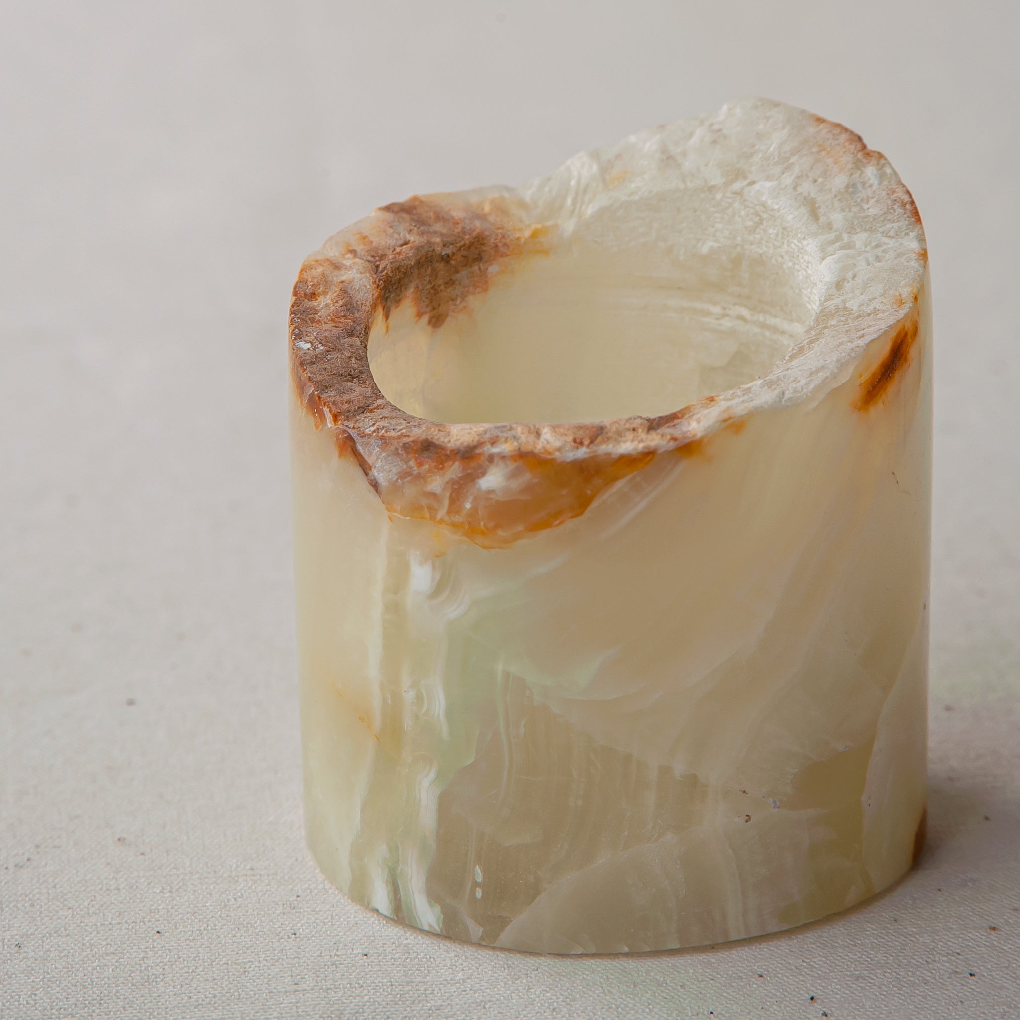 handcrafted onyx candle holder with raw edge ivory and amber veining for modern decor