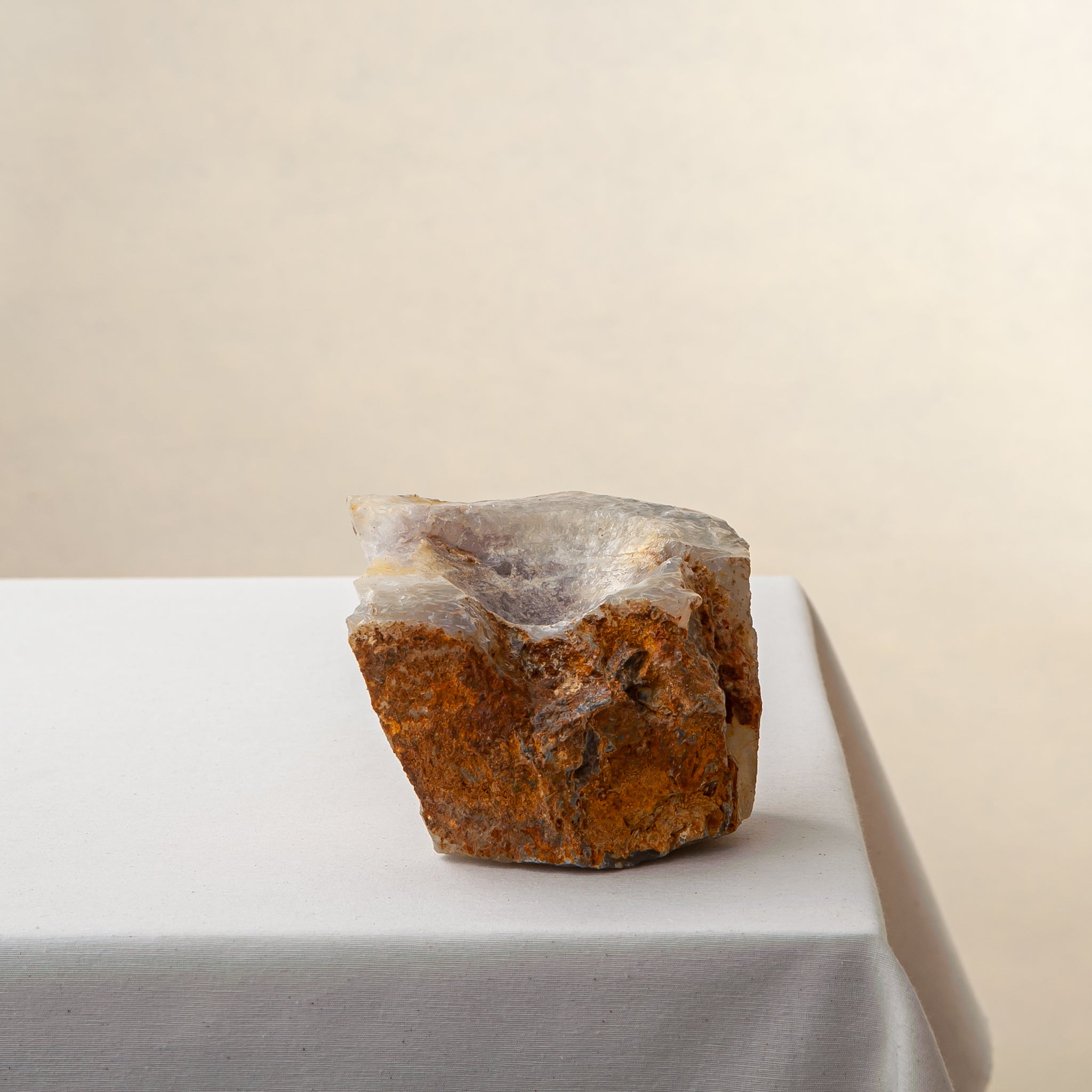 Handcrafted onyx candle holder with raw texture and amber rust tones for modern decor
