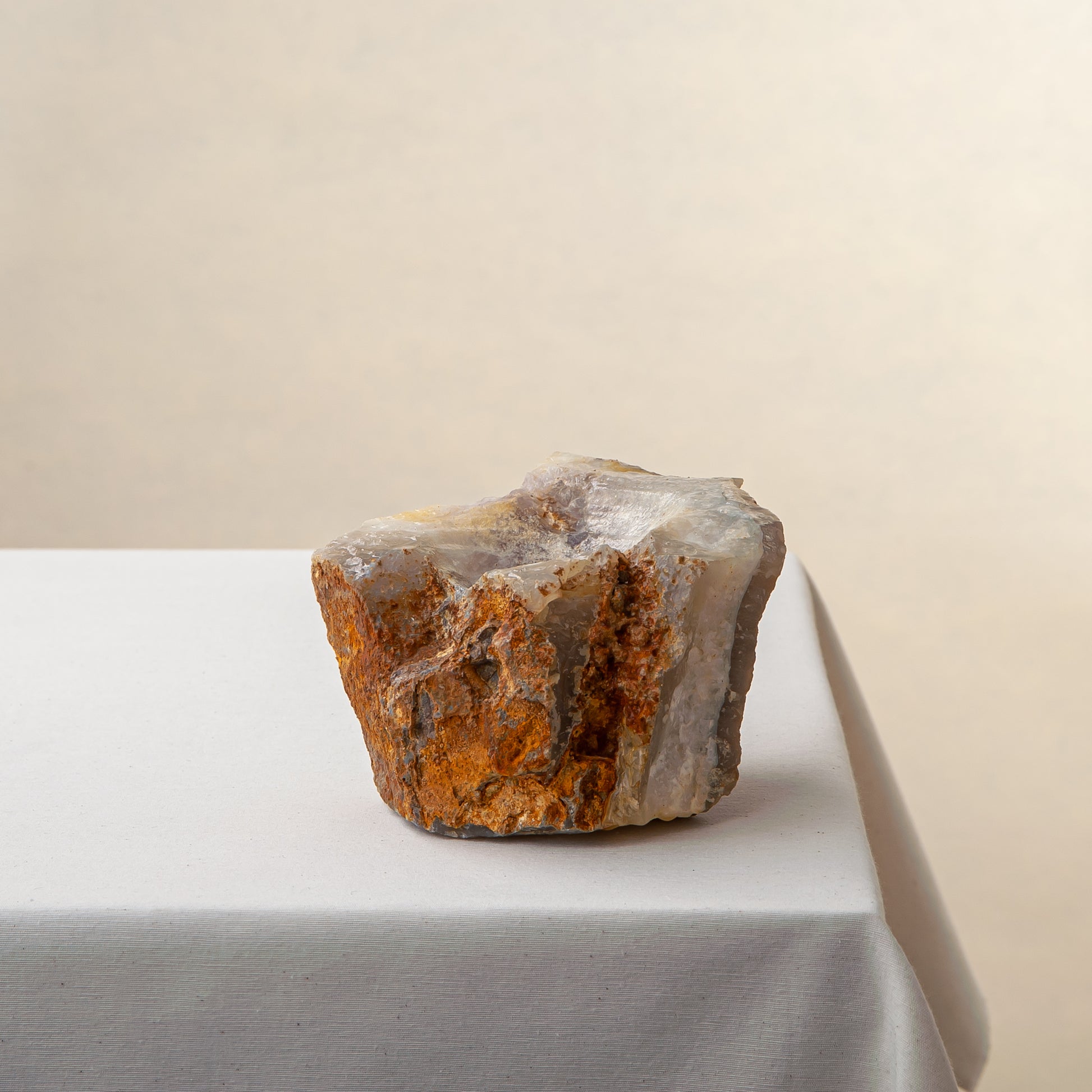 Handcrafted onyx candle holder with raw texture and amber rust tones for modern decor
