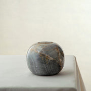 handcrafted onyx candle holder with rounded shape and dark grey amber veining
