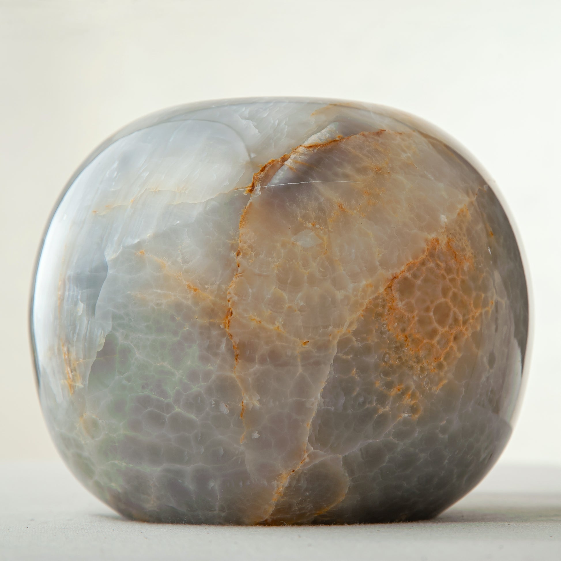 handcrafted onyx candle holder with rounded shape and dark grey amber veining
