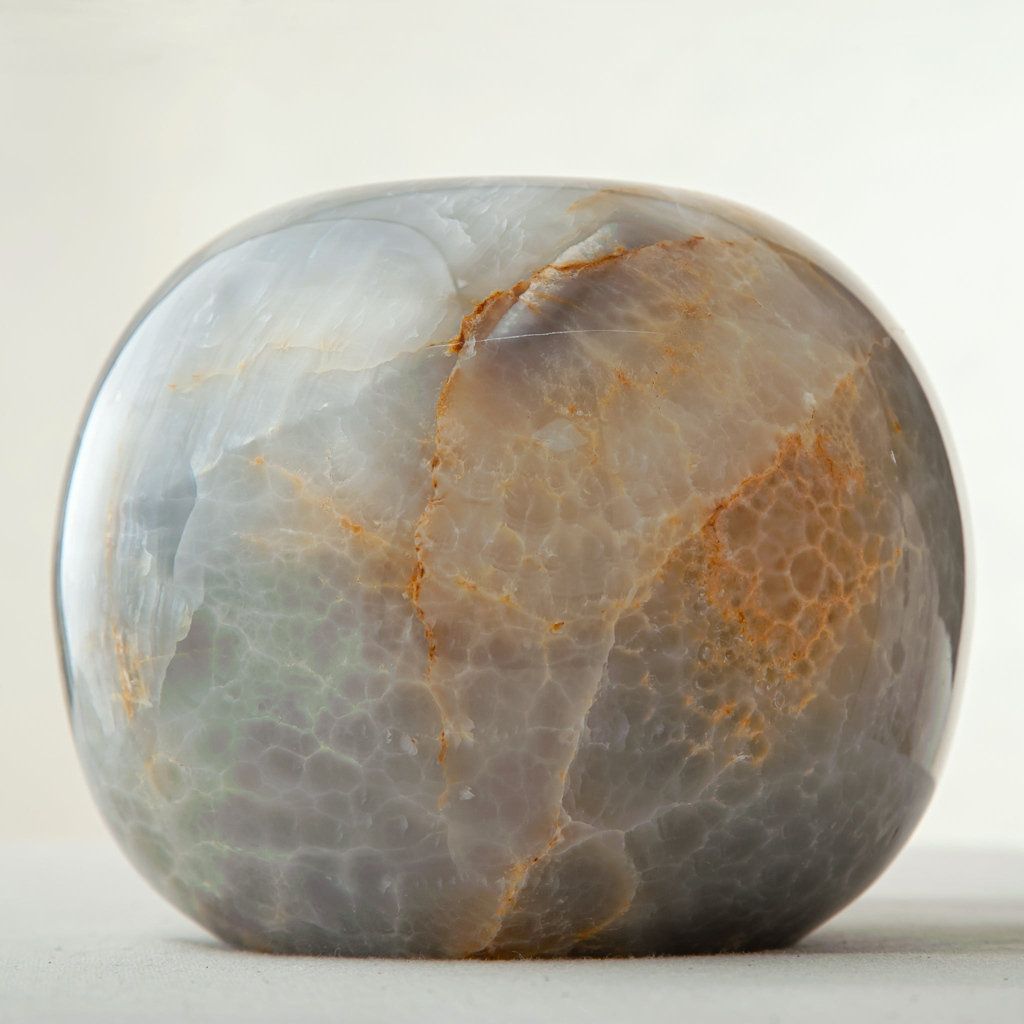 handcrafted onyx candle holder with rounded shape and dark grey amber veining
