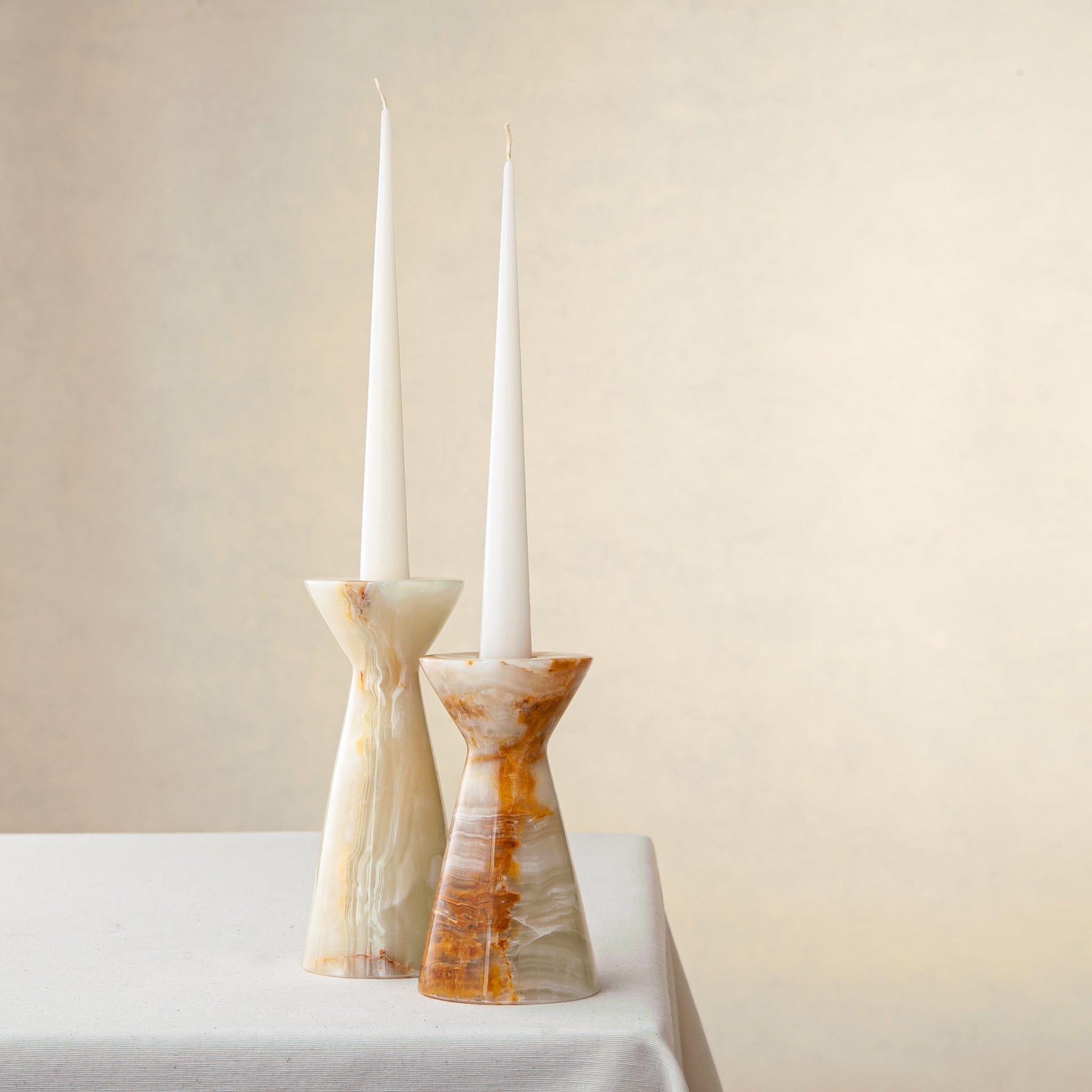 Unique handcrafted set of two onyx candle holders with ivory and amber veining
