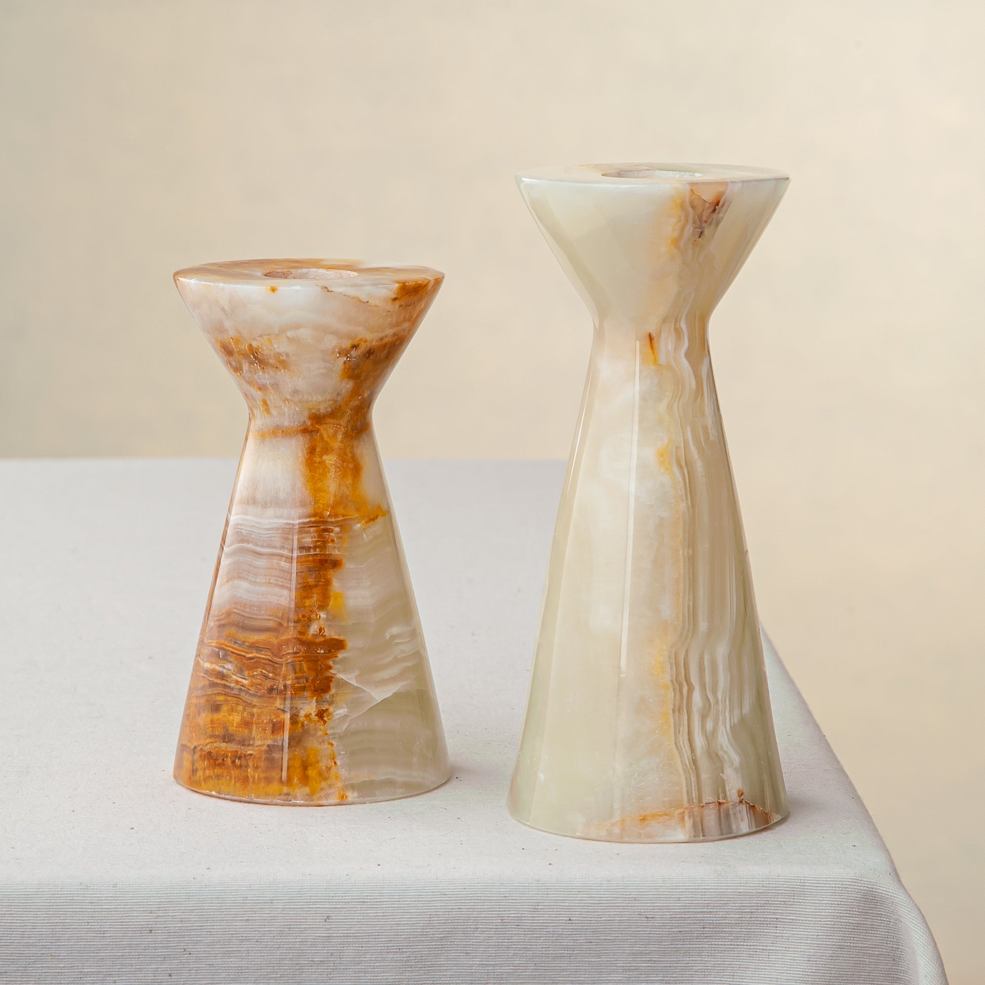 Unique handcrafted set of two onyx candle holders with ivory and amber veining
