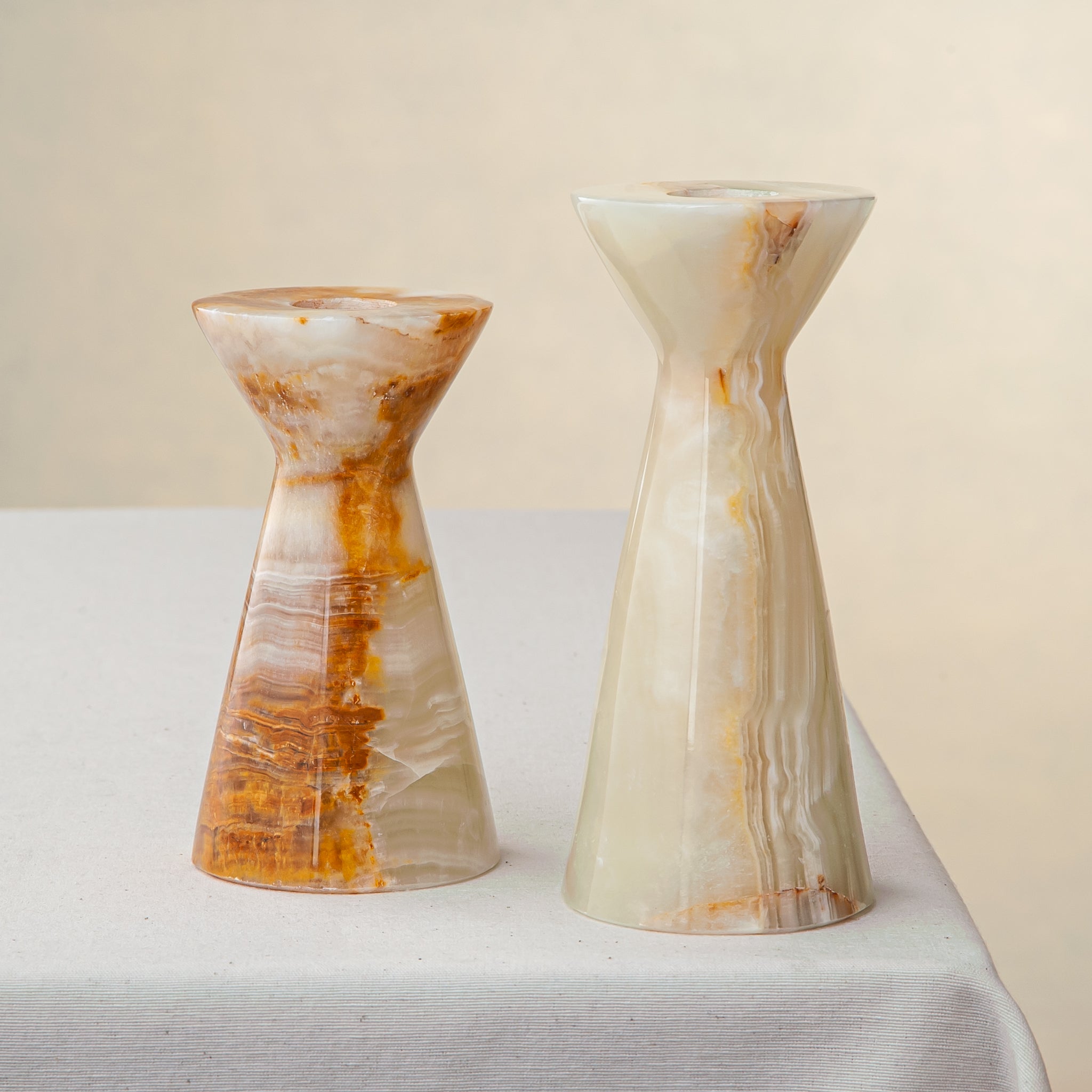Unique handcrafted set of two onyx candle holders with ivory and amber veining
