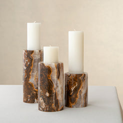 Handcrafted onyx candle holders featuring layered texture and warm earthy colors for elegant table decor
