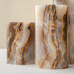 Handcrafted onyx candle holders featuring layered texture and warm earthy colors for elegant table decor
