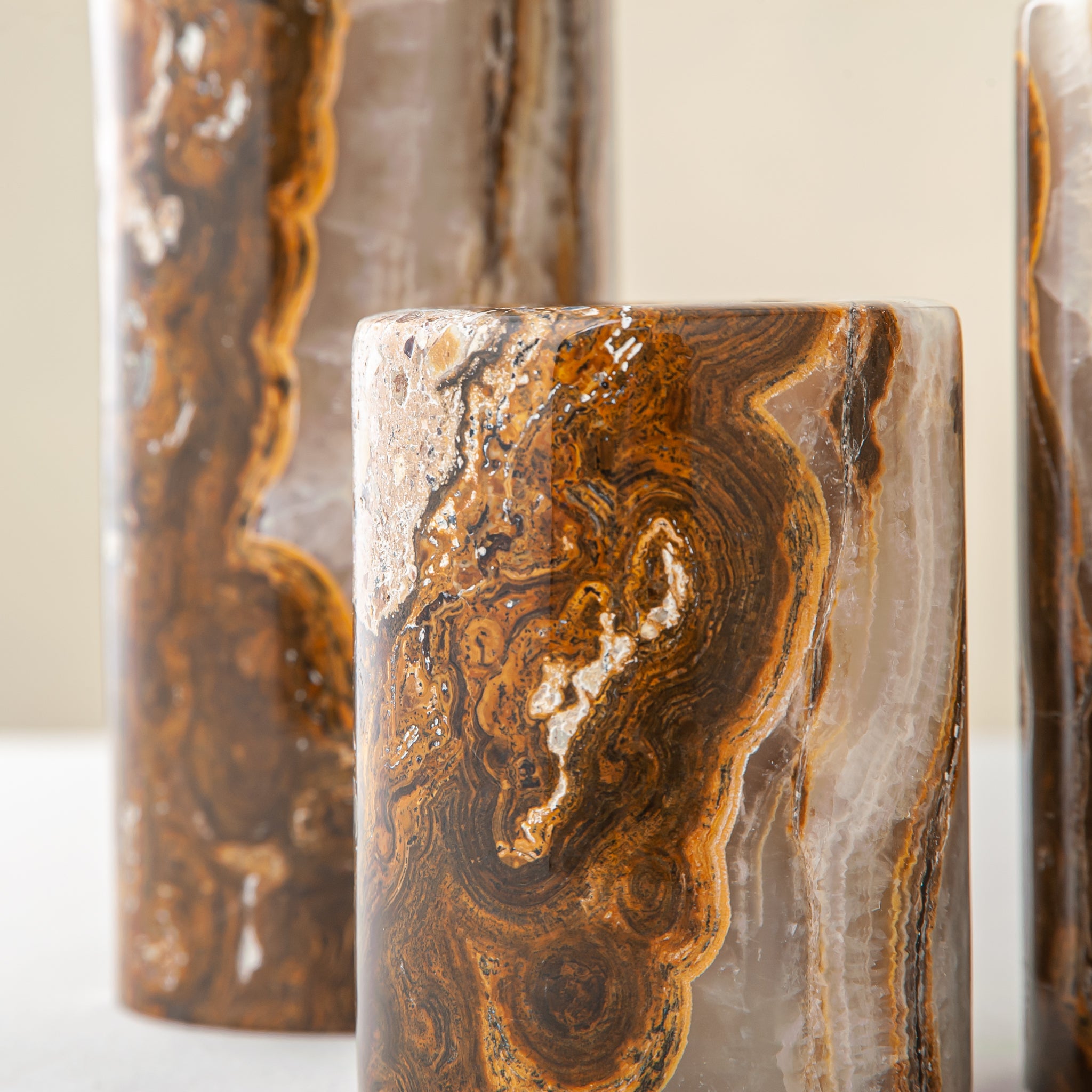 Handcrafted onyx candle holders featuring layered texture and warm earthy colors for elegant table decor
