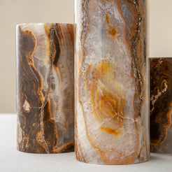 Handcrafted onyx candle holders featuring layered texture and warm earthy colors for elegant table decor
