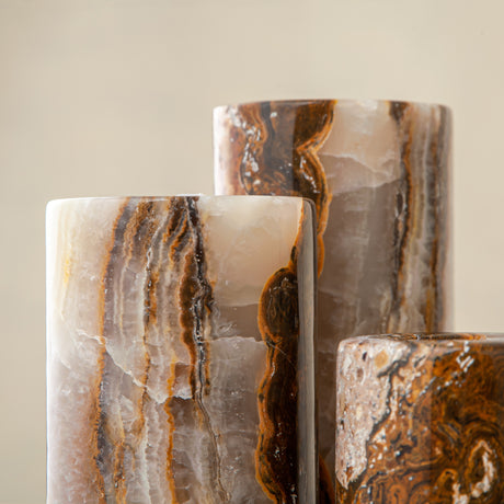 Handcrafted onyx candle holders featuring layered texture and warm earthy colors for elegant table decor
