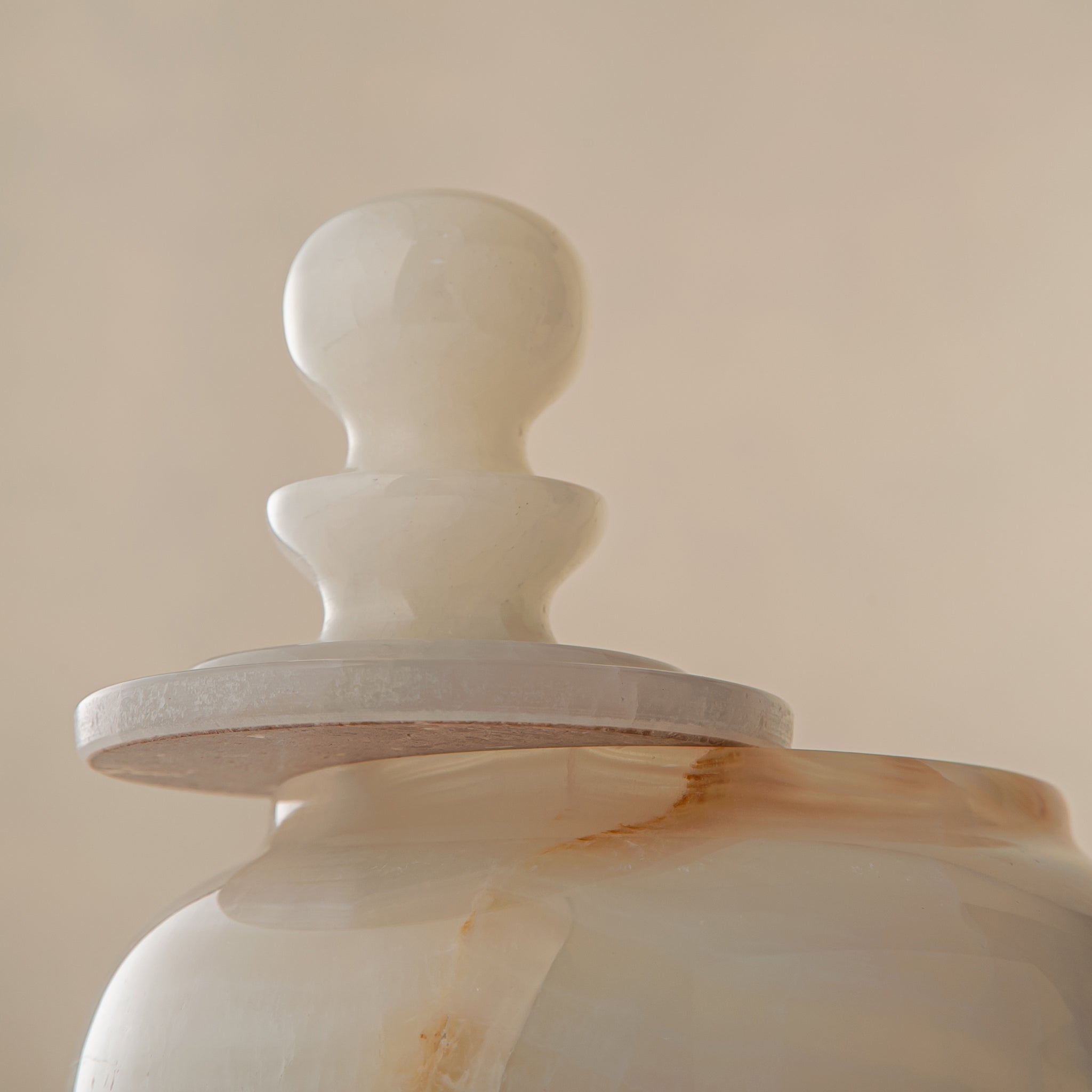 handcrafted onyx jar with translucent ivory stone and warm amber veining

