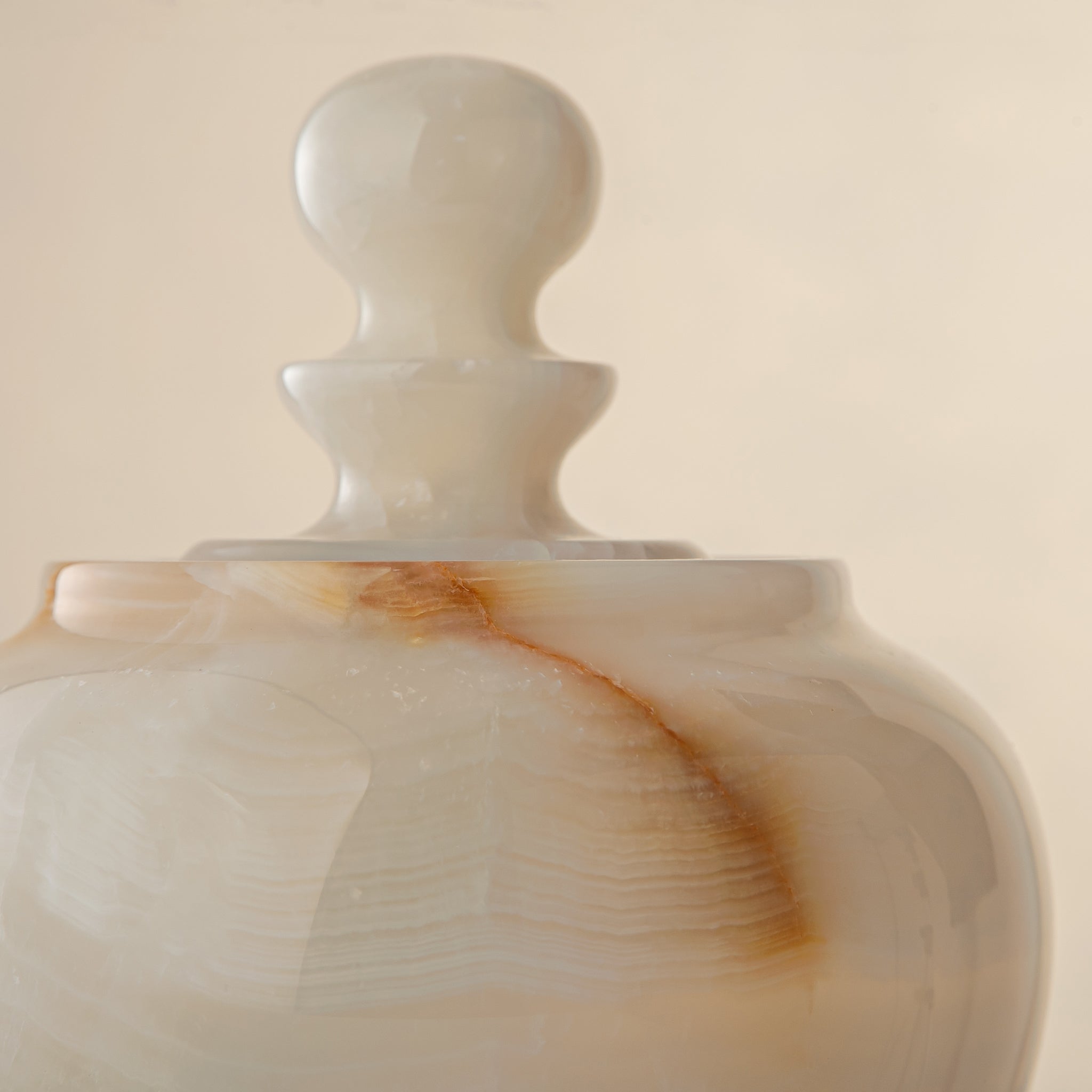 handcrafted onyx jar with translucent ivory stone and warm amber veining
