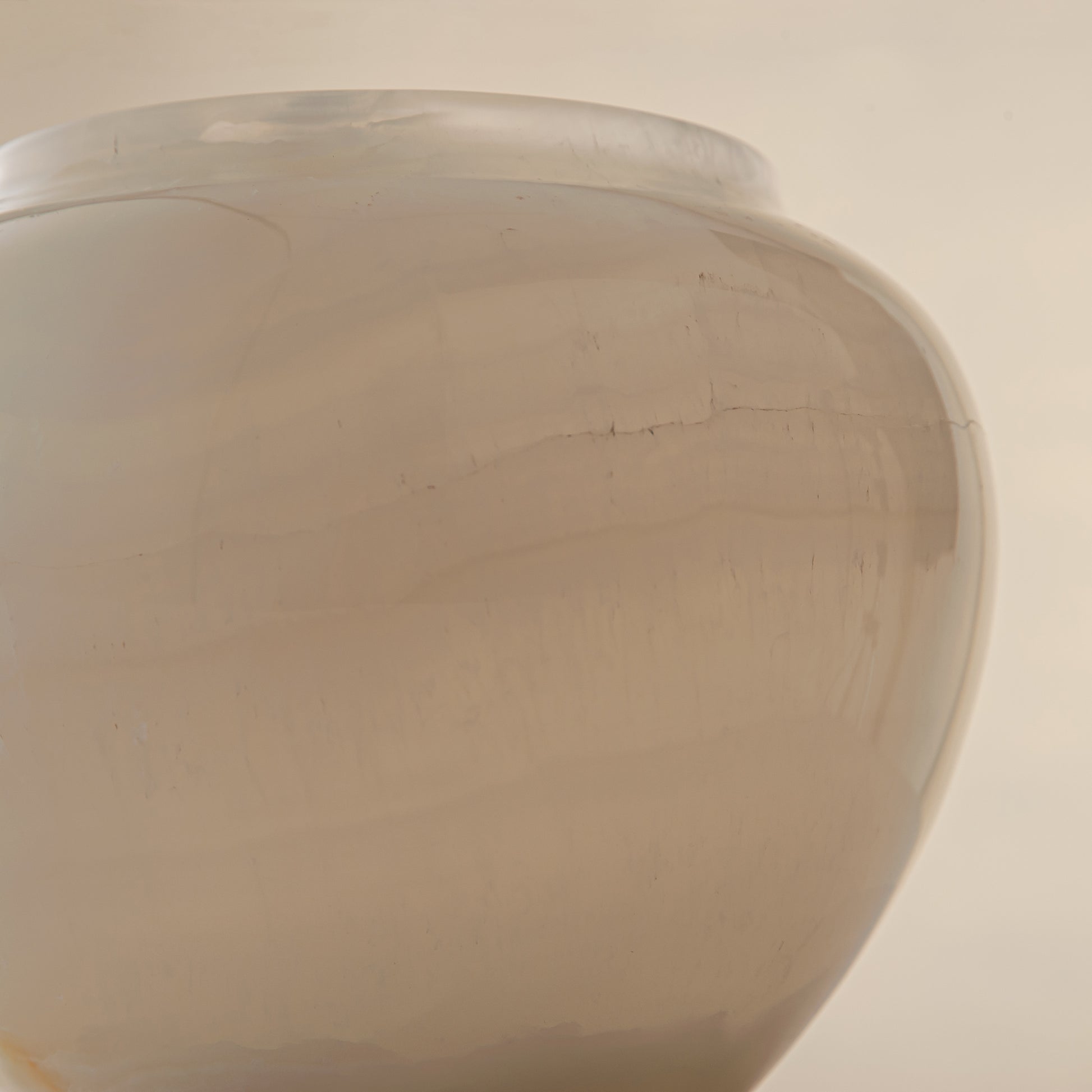 handcrafted onyx jar with translucent ivory stone and warm amber veining
