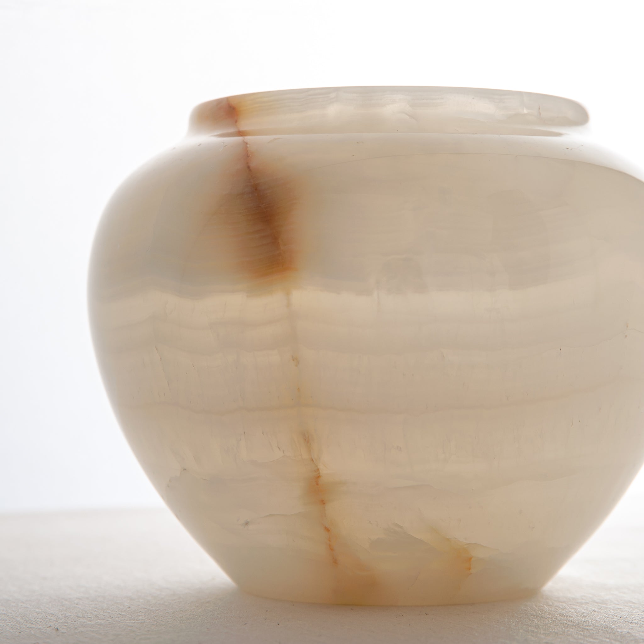 handcrafted onyx jar with translucent ivory stone and warm amber veining
