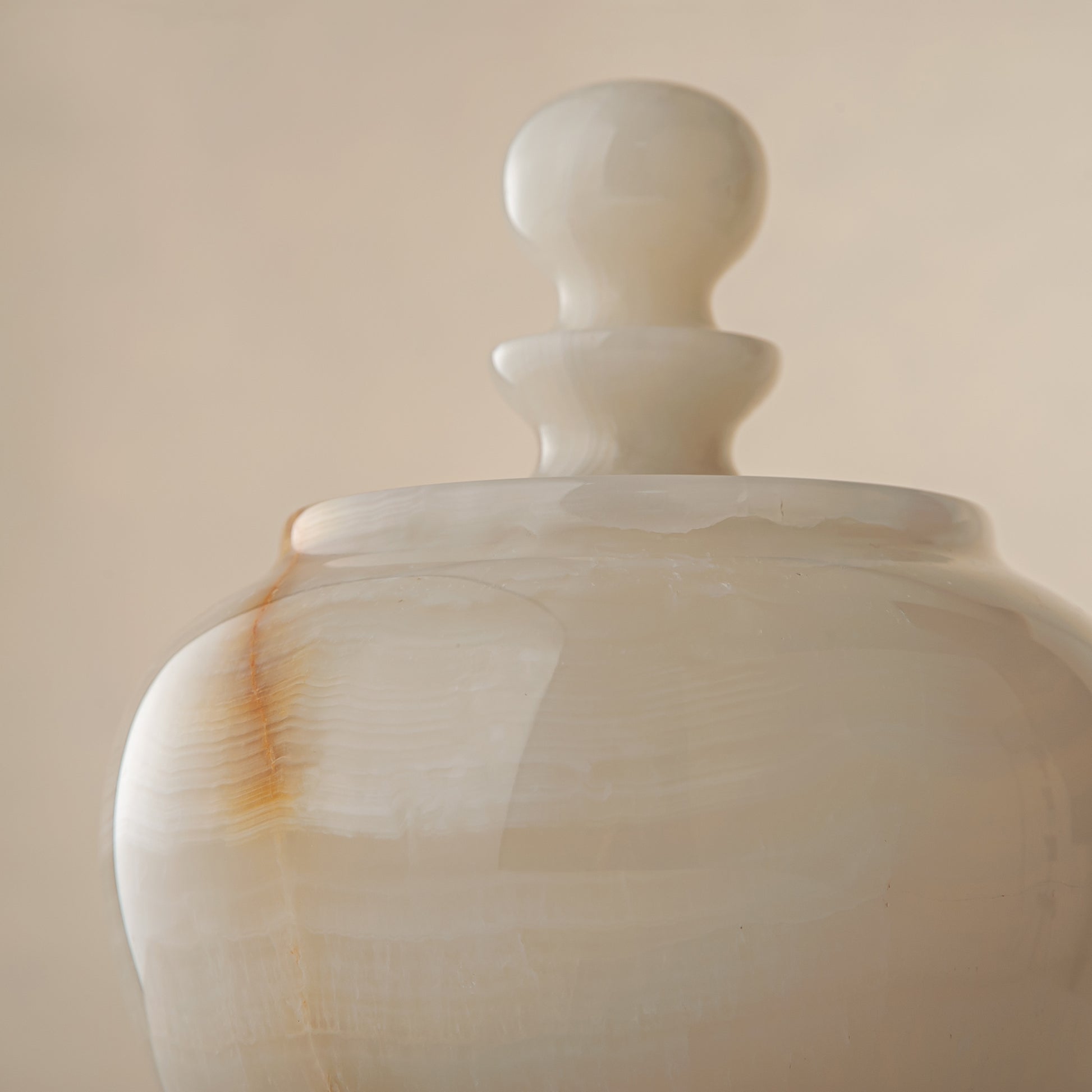 handcrafted onyx jar with translucent ivory stone and warm amber veining
