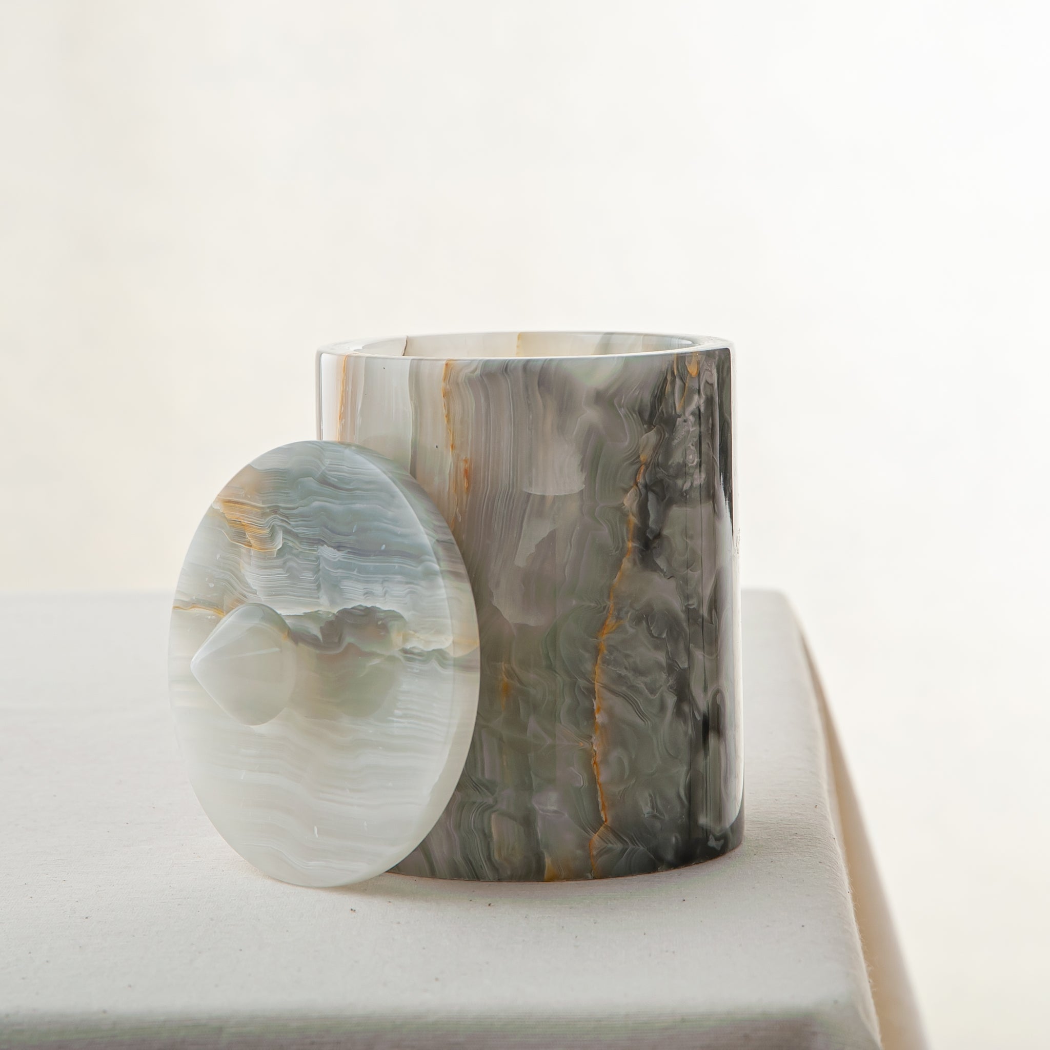 handcrafted onyx jar with lid in green and grey veining for luxury storage decor
