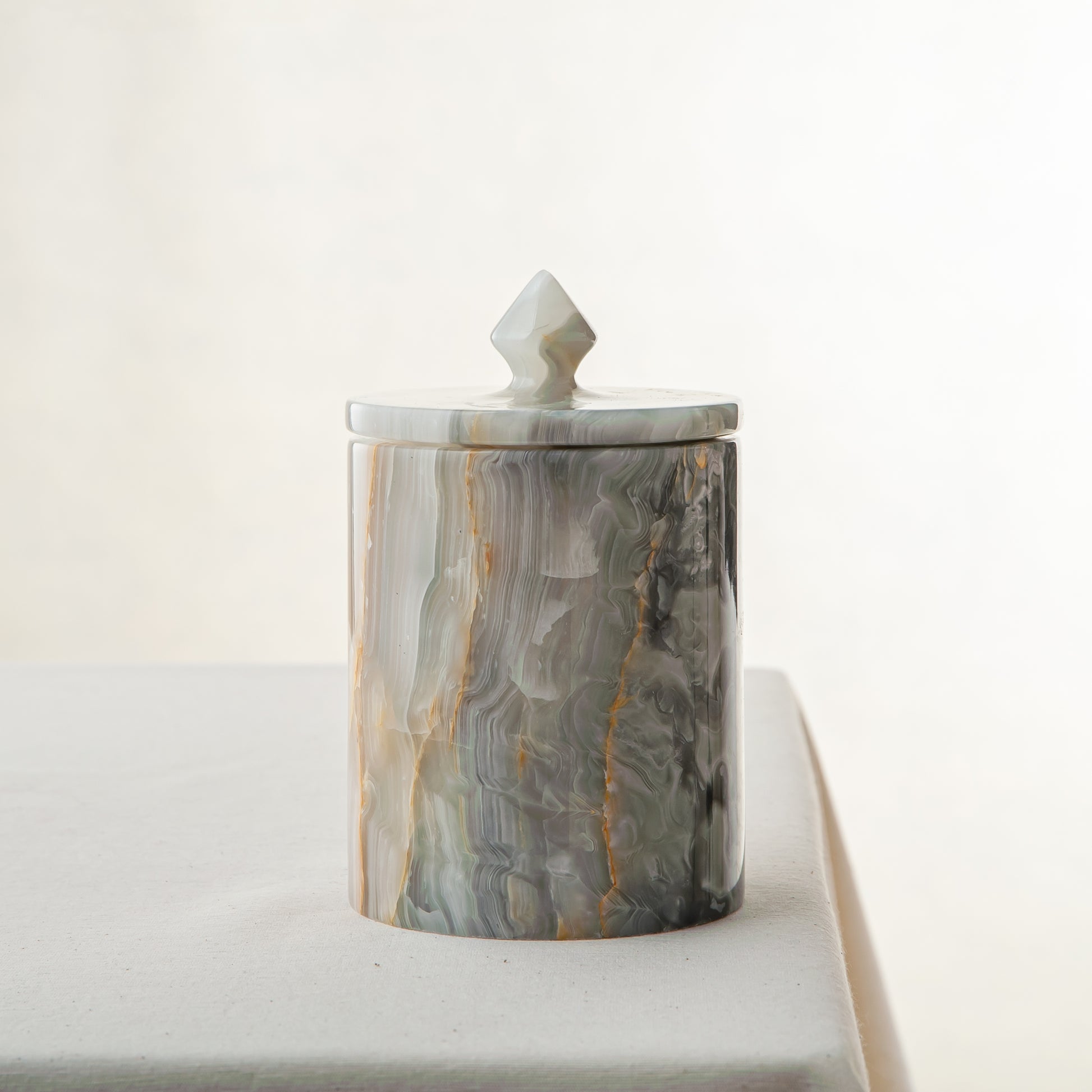 handcrafted onyx jar with lid in green and grey veining for luxury storage decor
