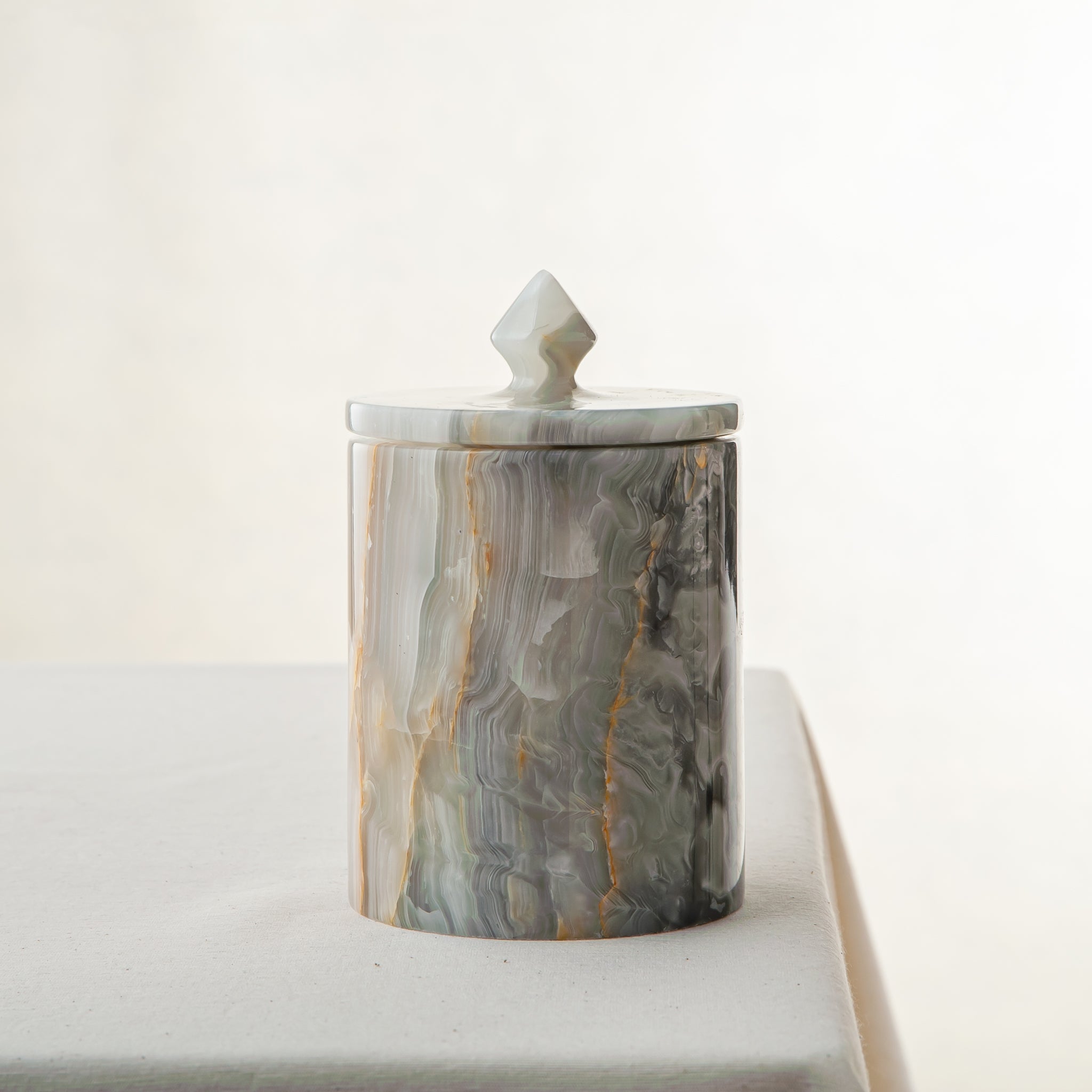 handcrafted onyx jar with lid in green and grey veining for luxury storage decor

