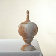 Handcrafted onyx jar with lid in translucent ivory and rust veining as sculptural centerpiece
