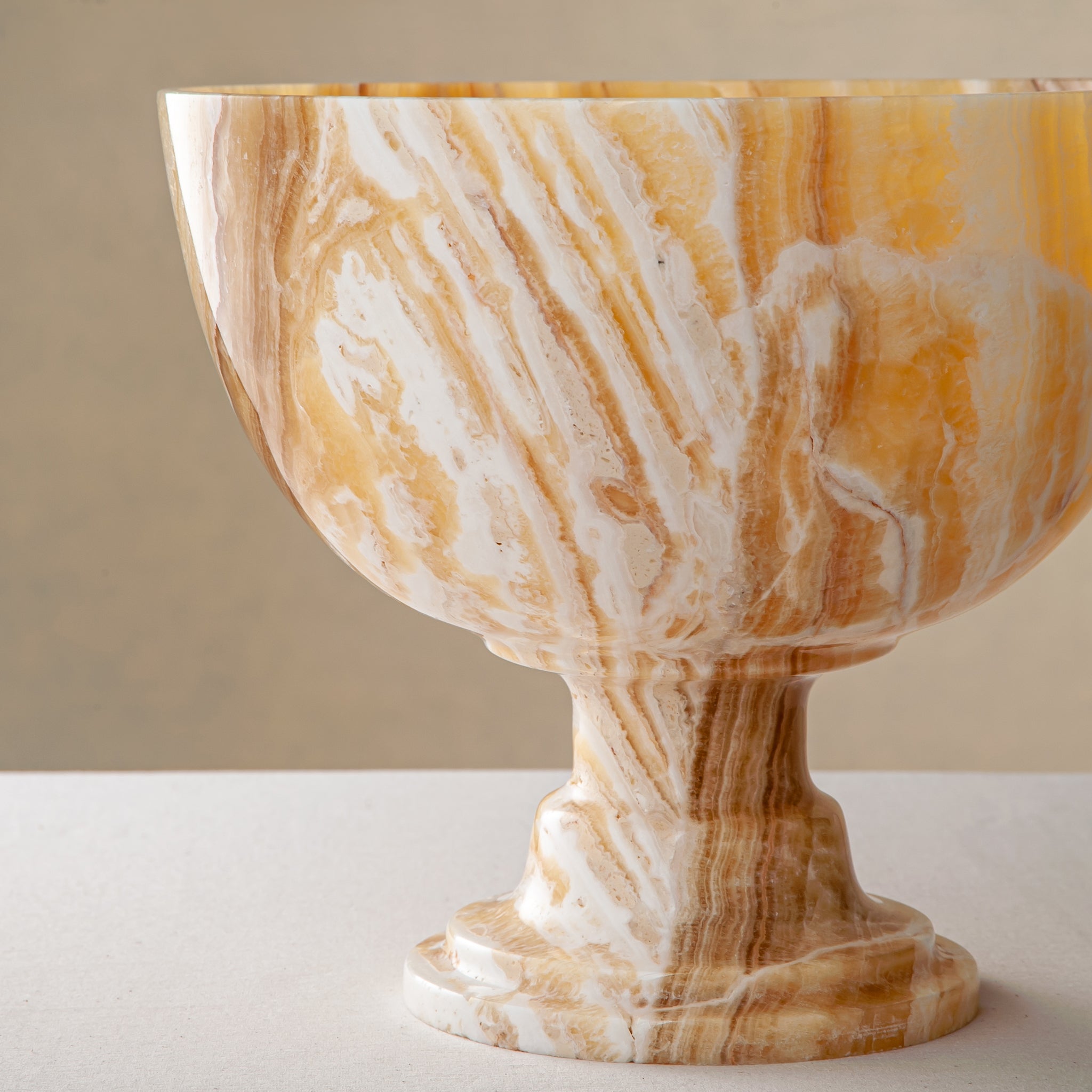handcrafted onyx bowl with pedestal base and striking circular veining for table decor